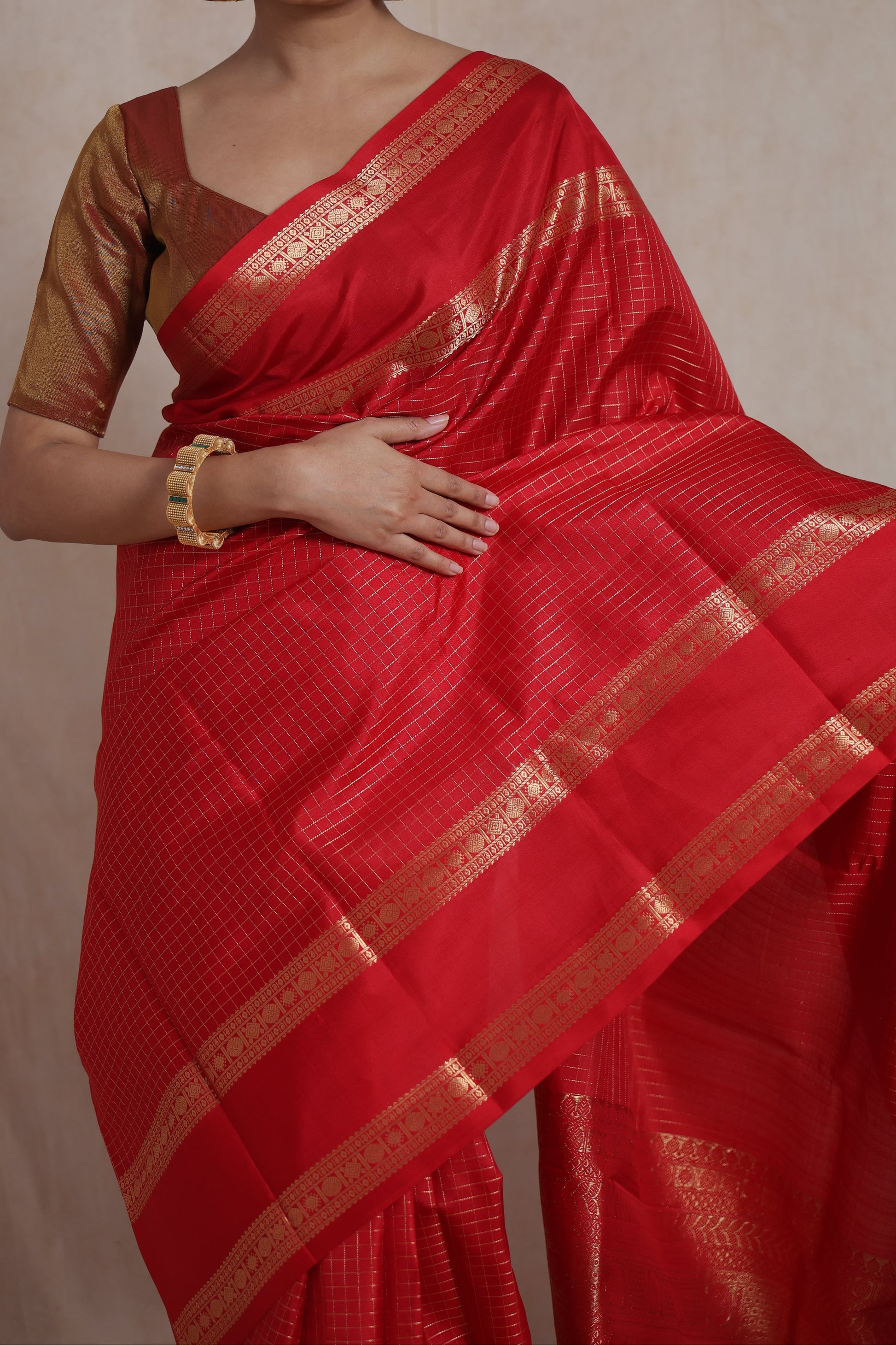 Close-up of crimson red Kanjivaram pure silk saree with intricate checks weaving and traditional border