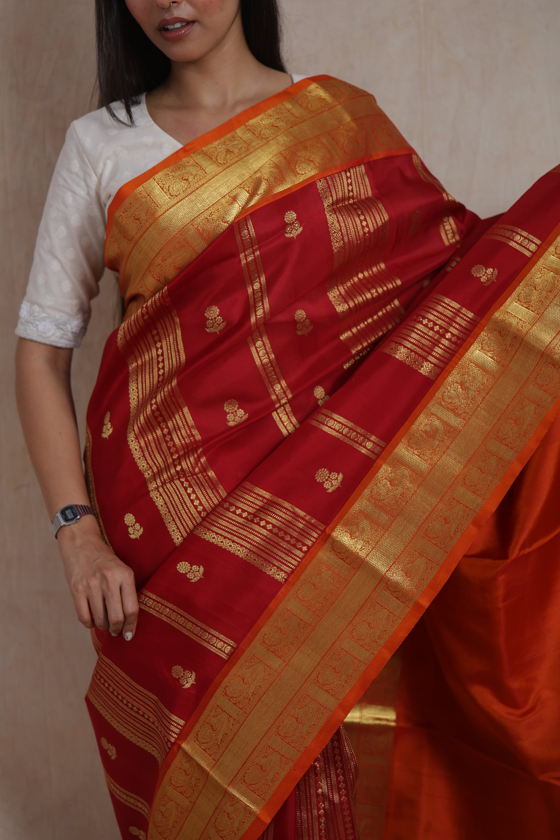 Close-up of crimson red Venkatgiri silk saree featuring woven buttas and broad border