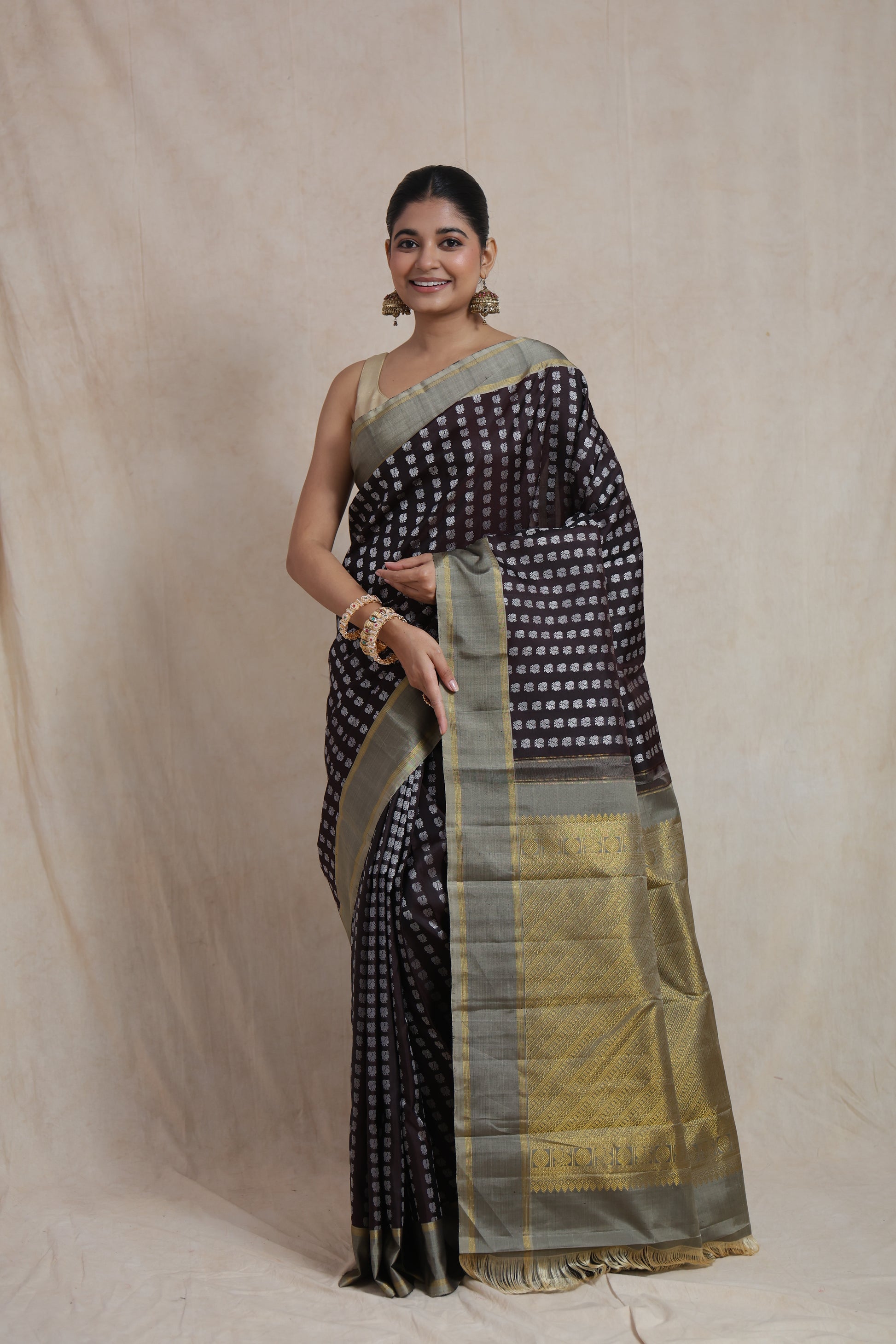 Front view of deep brown Kanjivaram silk saree with silver woven buttas