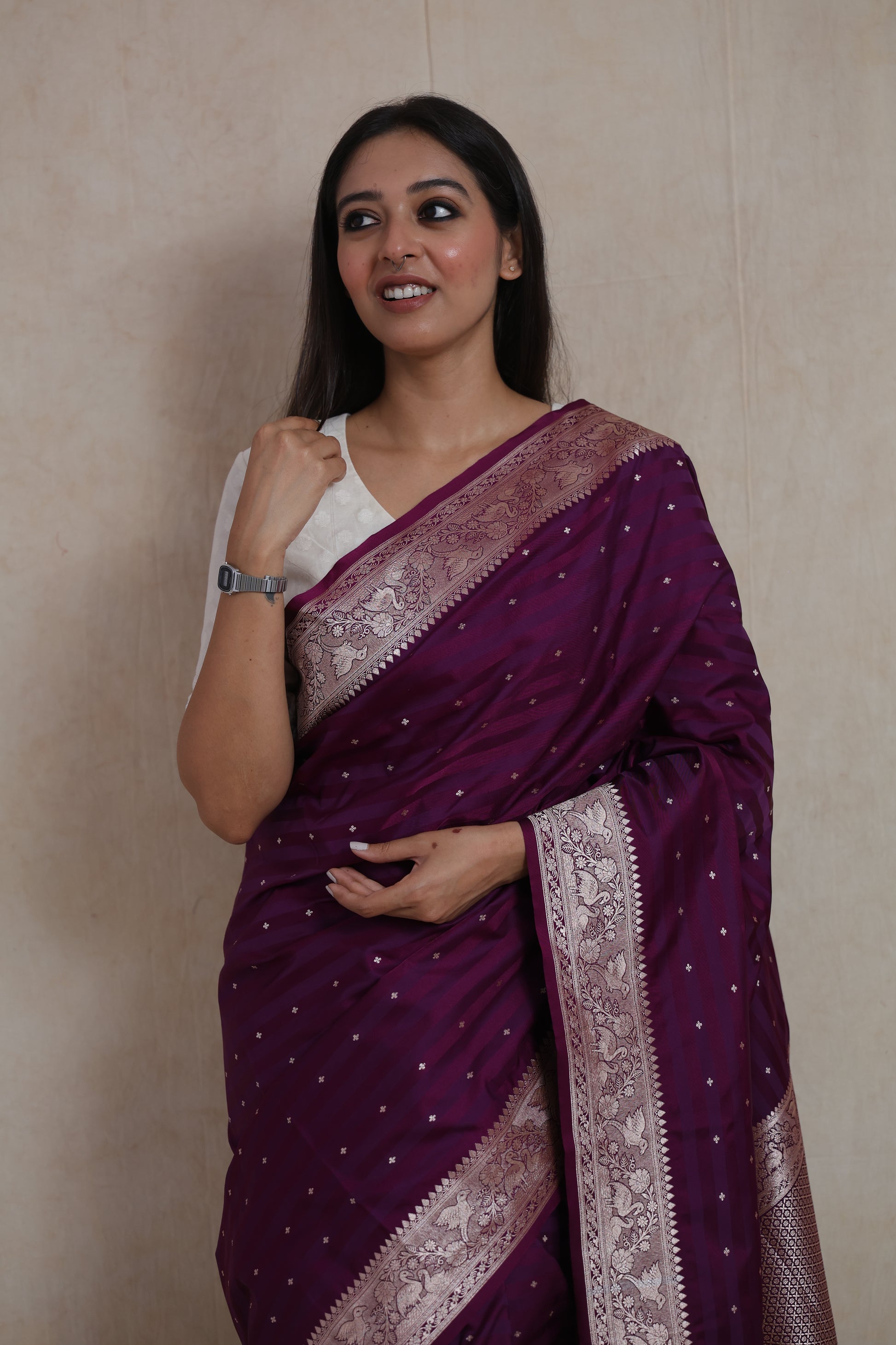 Fashion portrait featuring luxurious deep wine Banarasi saree with woven silver border.