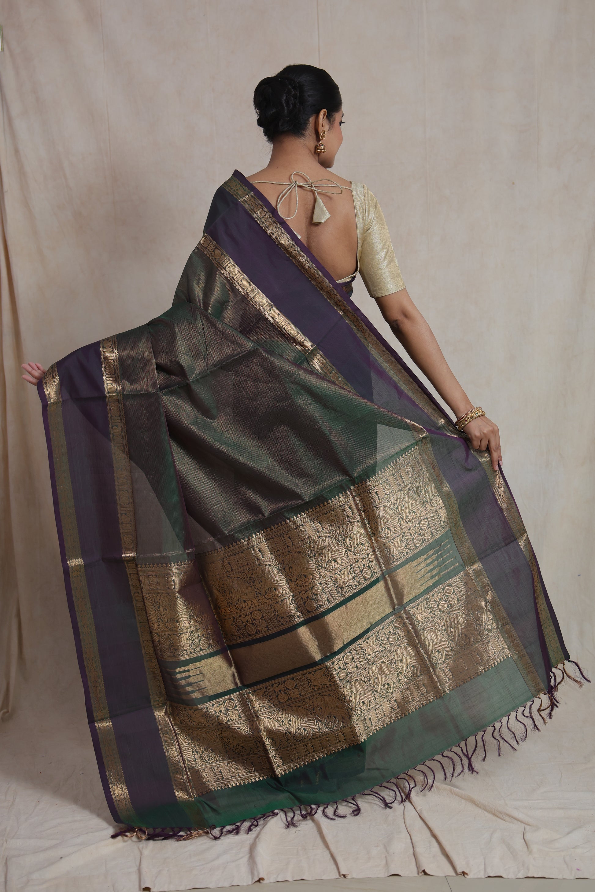 Back pallu view of dual-tone green and purple Kanchipuram silk saree with rich gold weaving