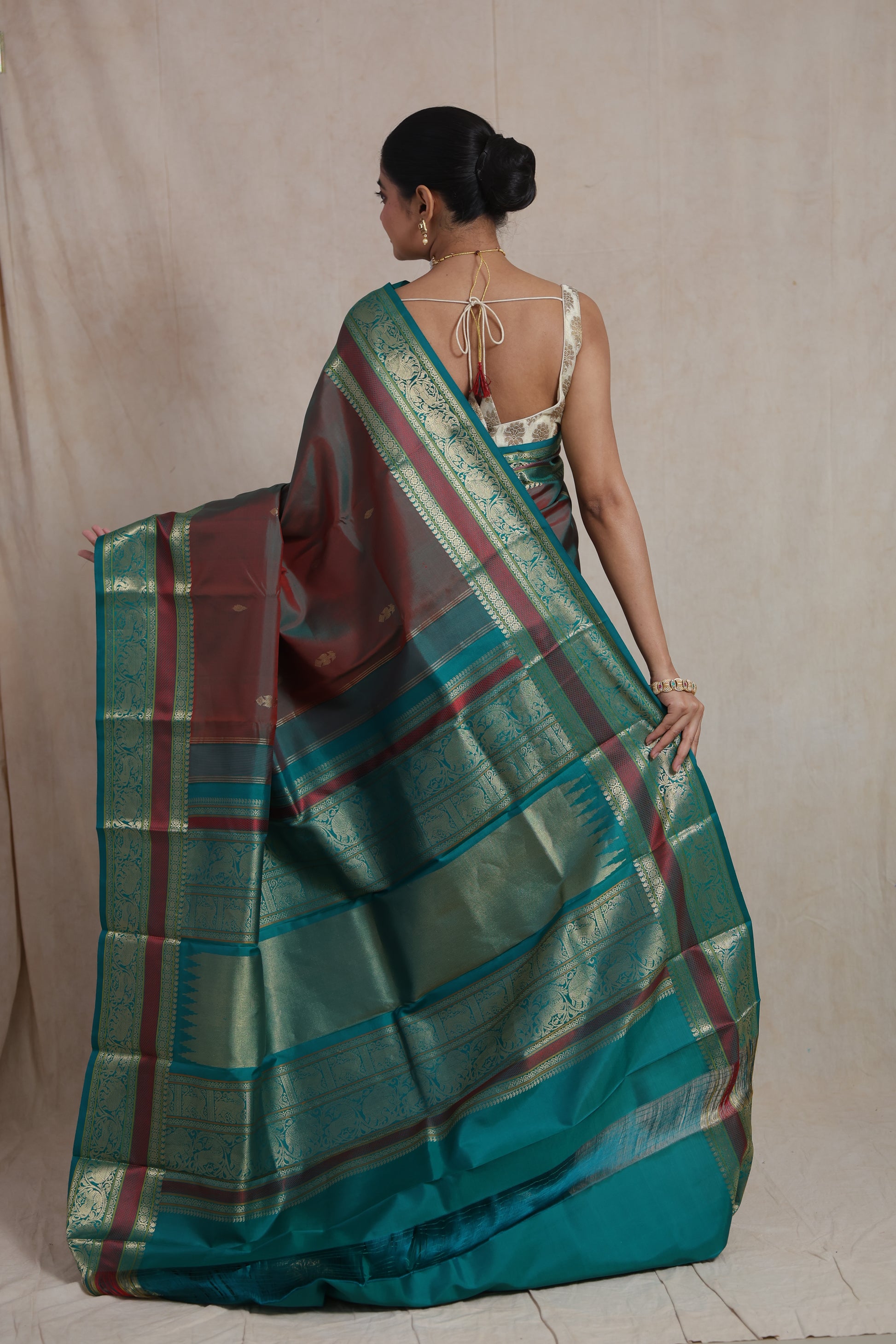 Model shot of luxurious dual-tone maroon teal Kanchiwaram silk saree