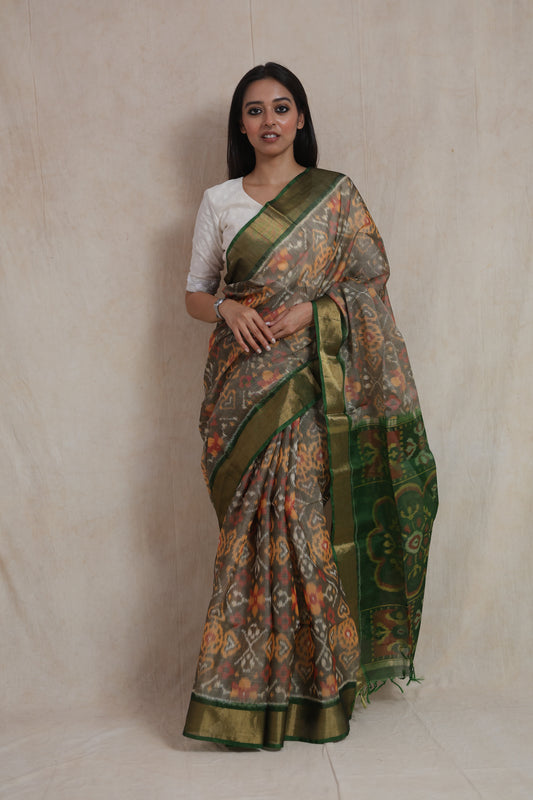 Front view of earthy taupe Panchampali handloom silk cotton saree with emerald green floral pallu and golden border