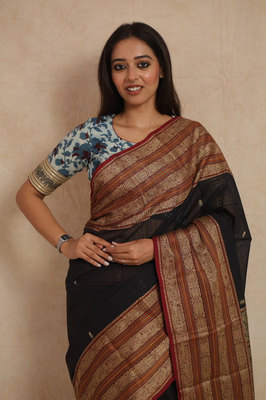 Elegant black Kanchipuram handloom cotton saree with heritage-inspired woven craftsmanship