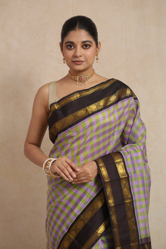 Full look of lavender and olive green Kanchipuram Sico saree with woven border