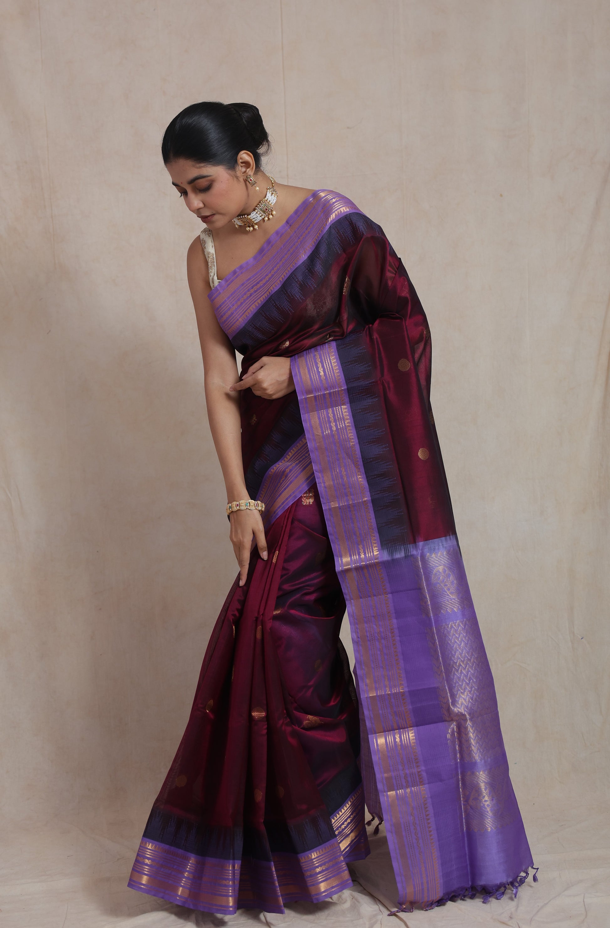 Elegant drape of wine purple Kanjipuram silk cotton saree with contrast border