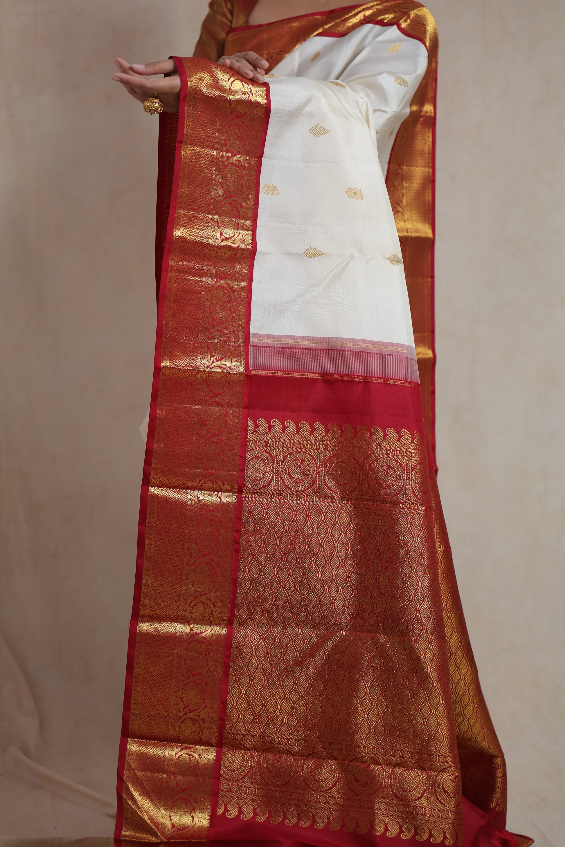 Elegant ivory and red Kanjivaram pure silk saree draped for festive and bridal occasions