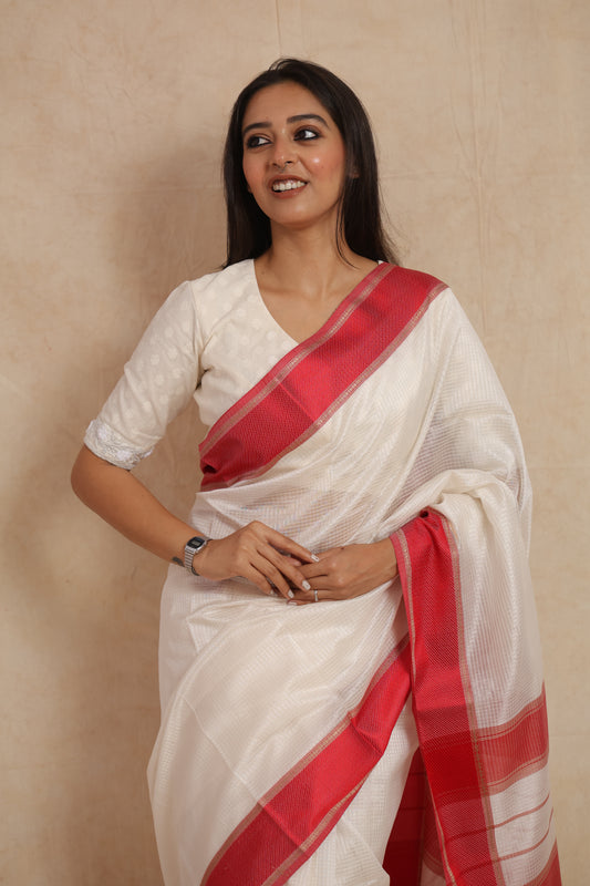 Close-up of ivory white Maheshwari handloom silk saree with rich crimson woven border