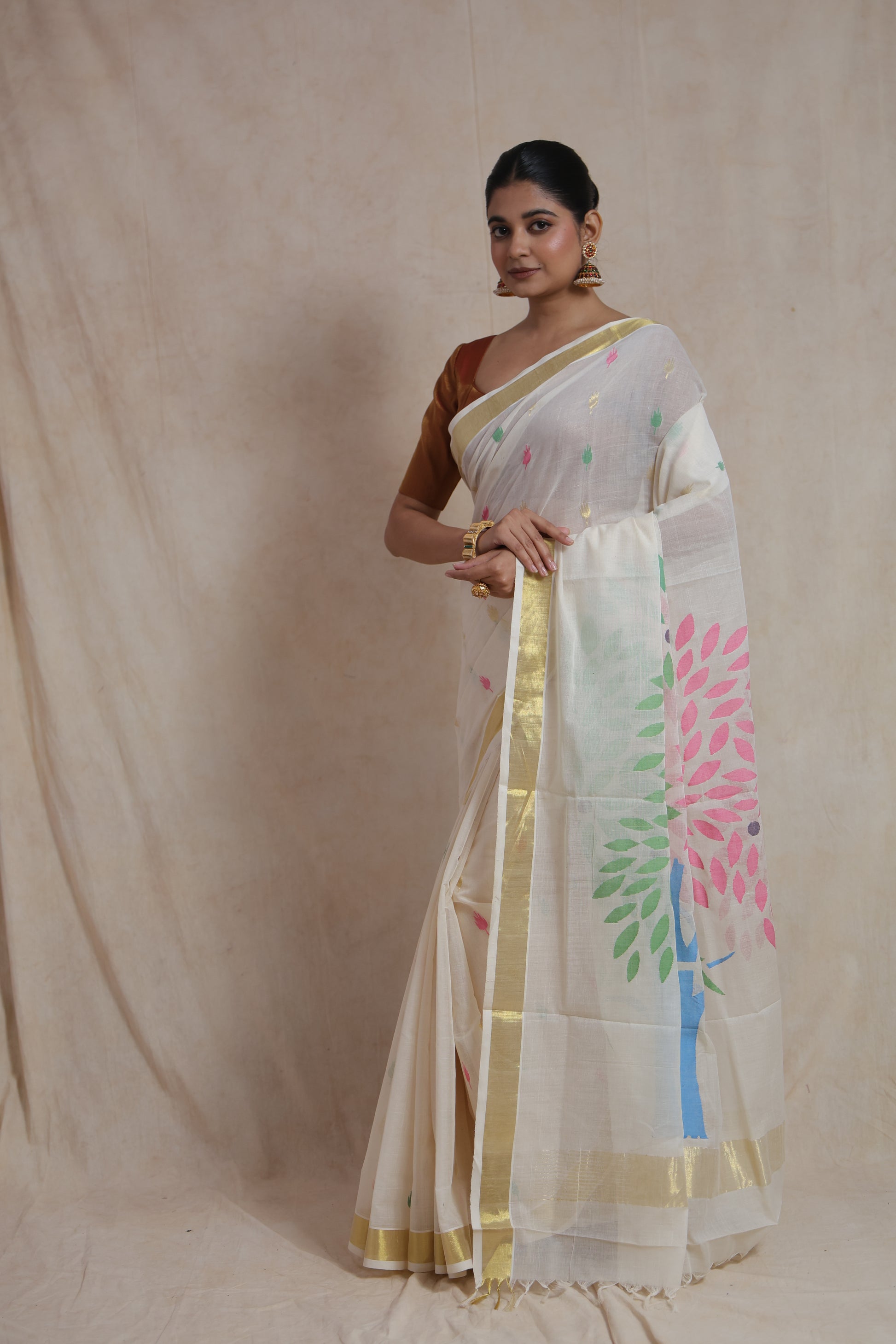 Front pose of off white Kanchipuram cotton saree with golden zari border