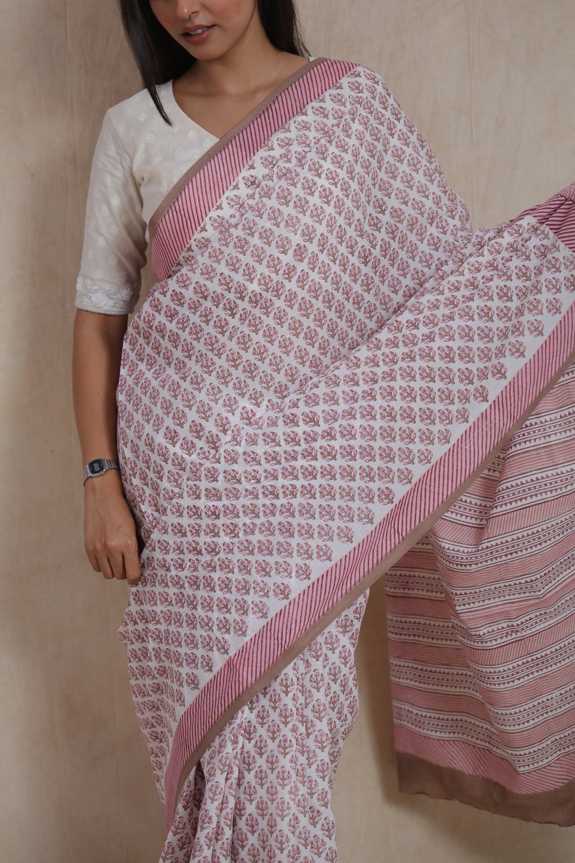 Close-up of white and dusty pink Sanghnaree cotton saree with floral buti prints