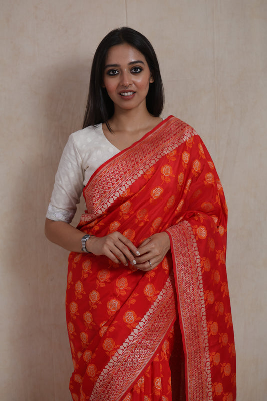 Front view of radiant red Banarasi art silk saree with floral zari motifs