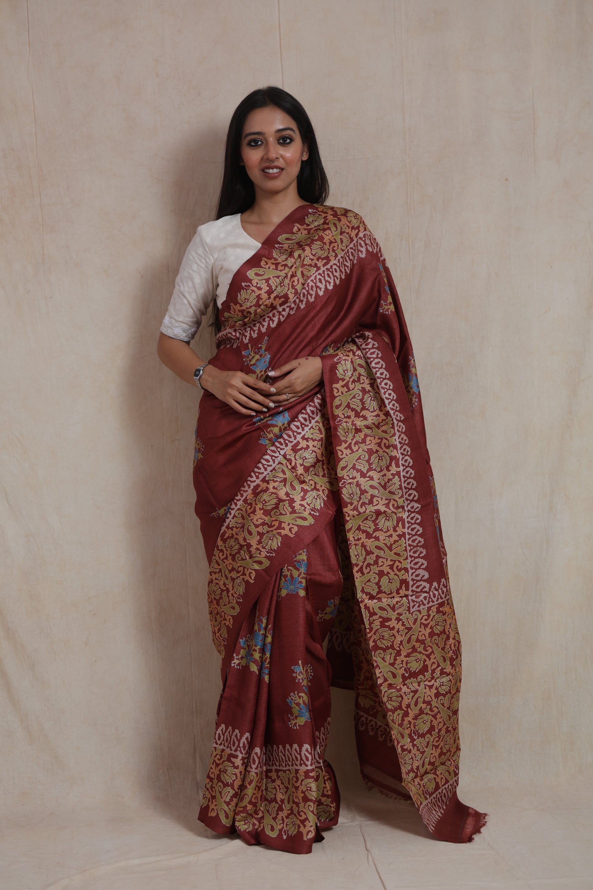 Portrait view of rust brown Batik silk saree with traditional handcrafted detailing