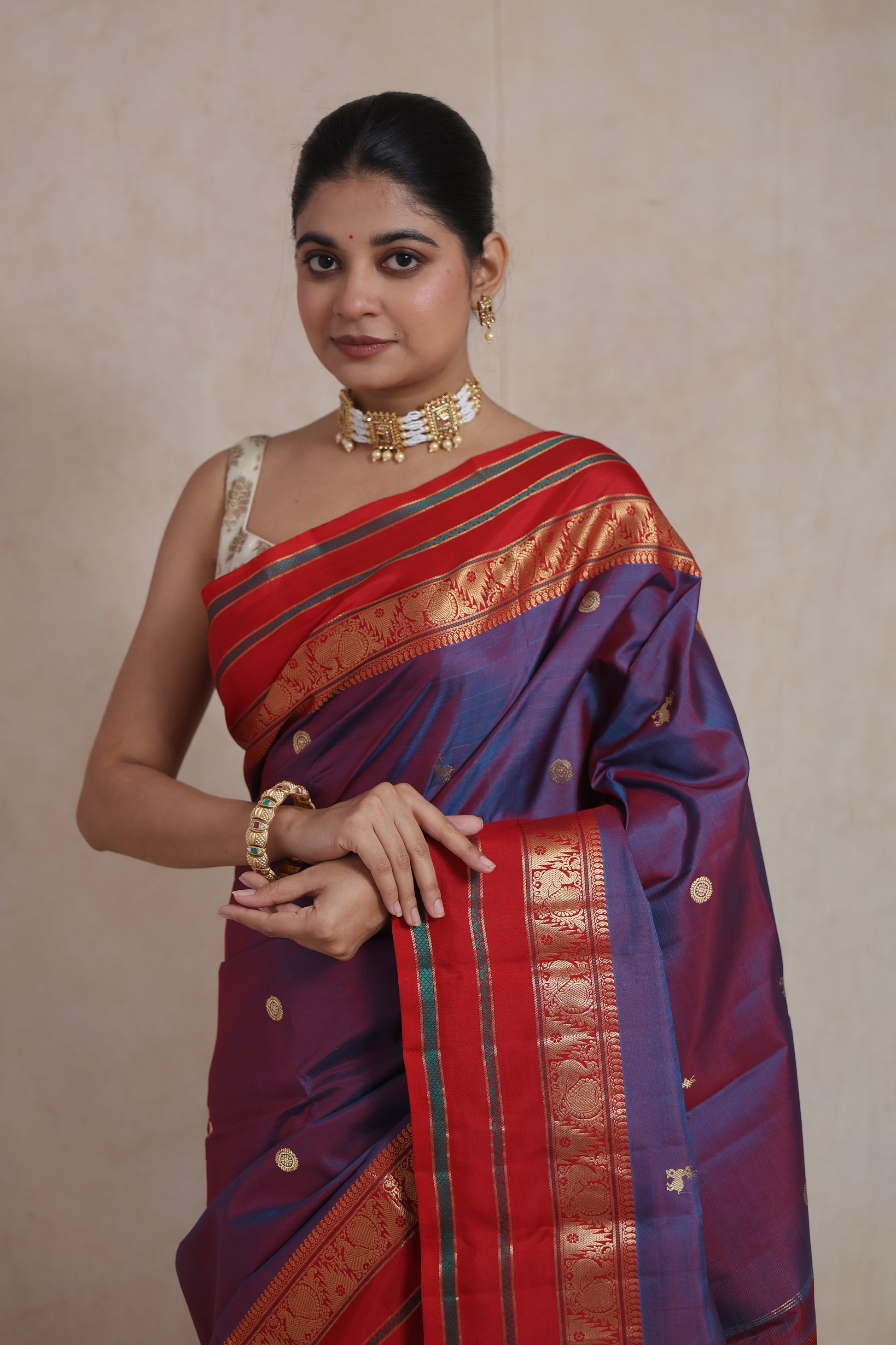 Portrait view of royal violet Kanjivaram silk saree with golden zari motifs