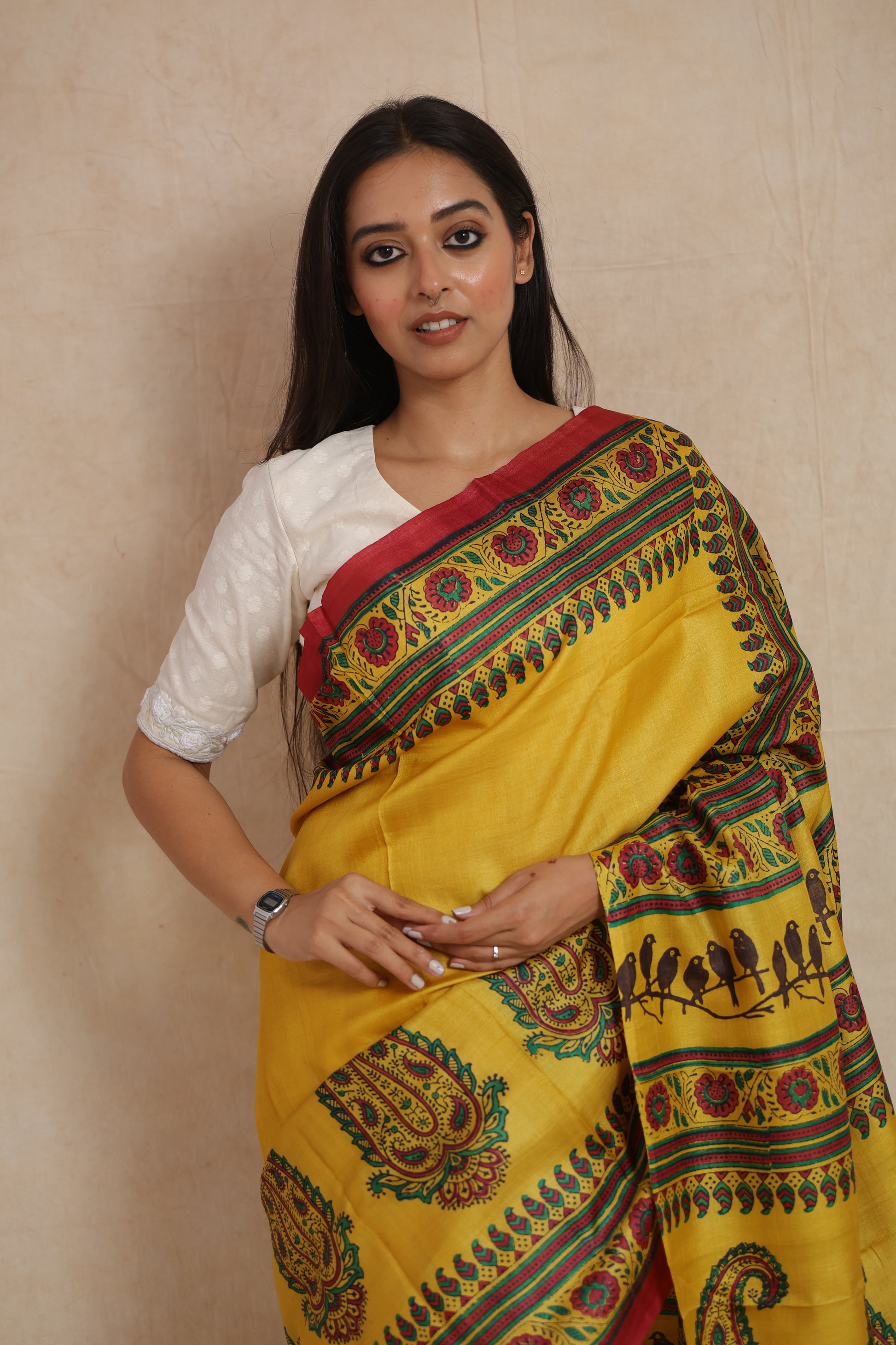 Model wearing sunshine yellow printed Tussar saree with traditional paisley motifs