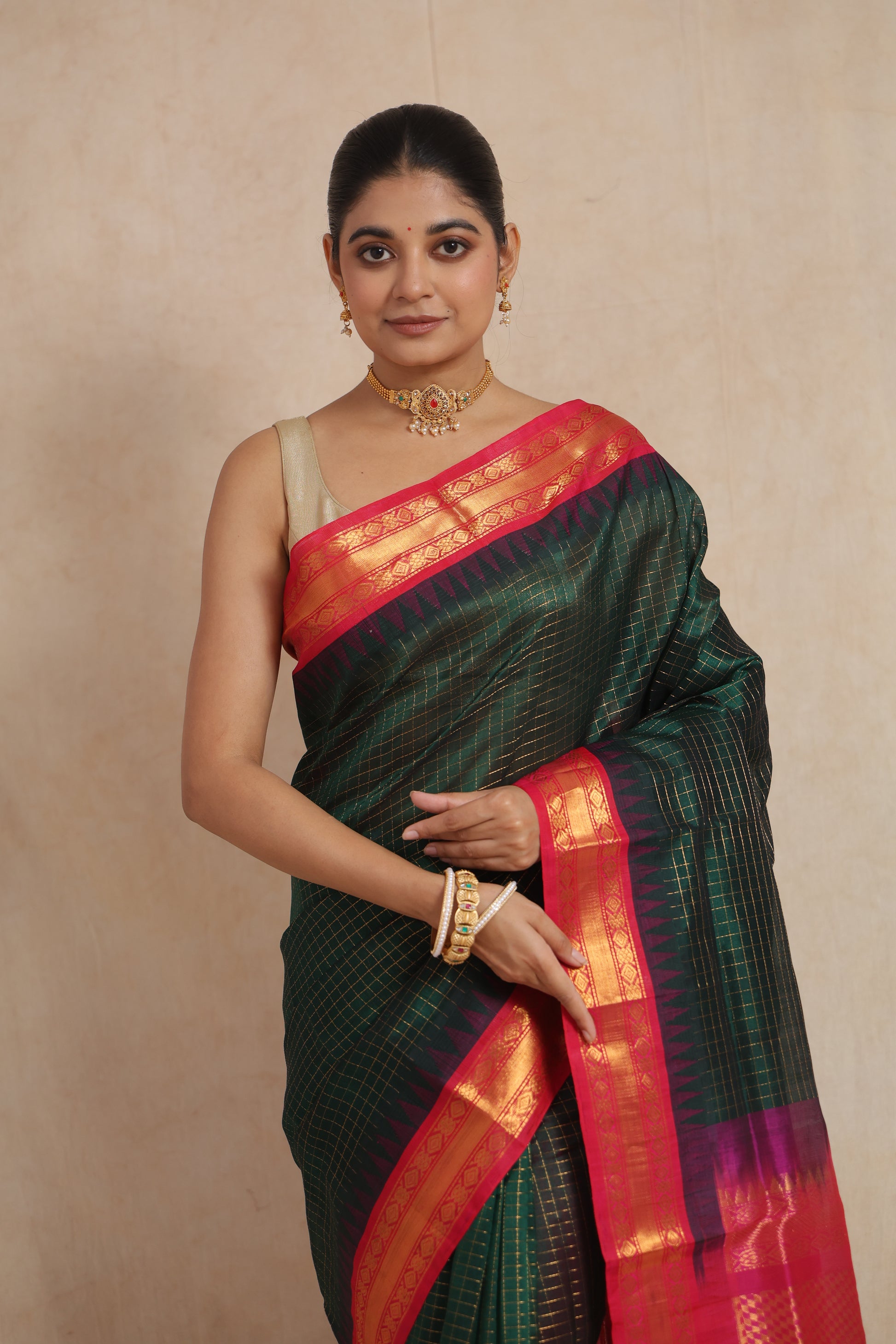 Portrait view of emerald green Kanchipuram Sico saree with magenta border