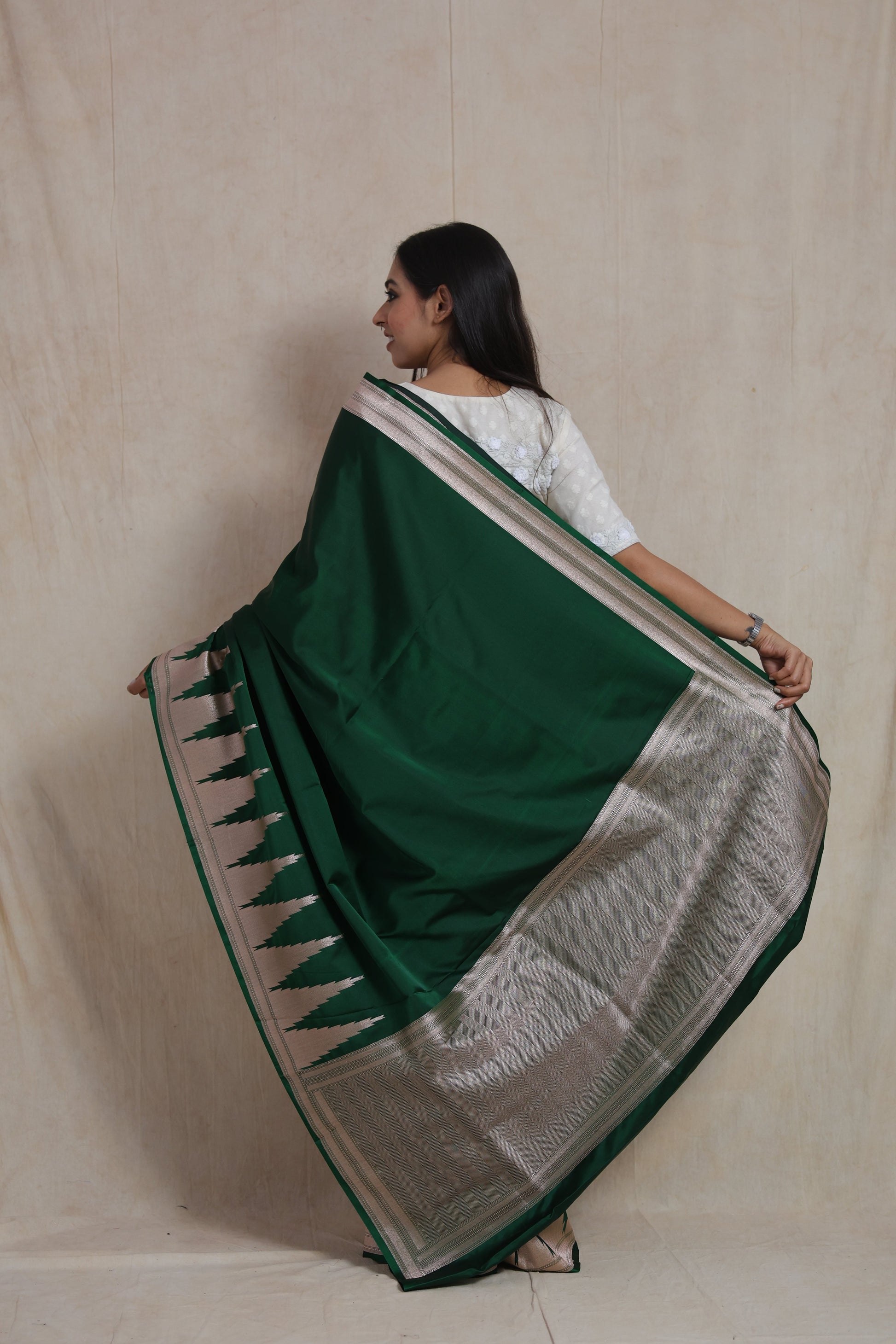 Back view of emerald green Banarasi art silk saree with silver woven border and rich pallu