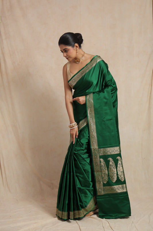 Elegant drape of emerald green Banarasi art silk saree showcasing woven border detailing