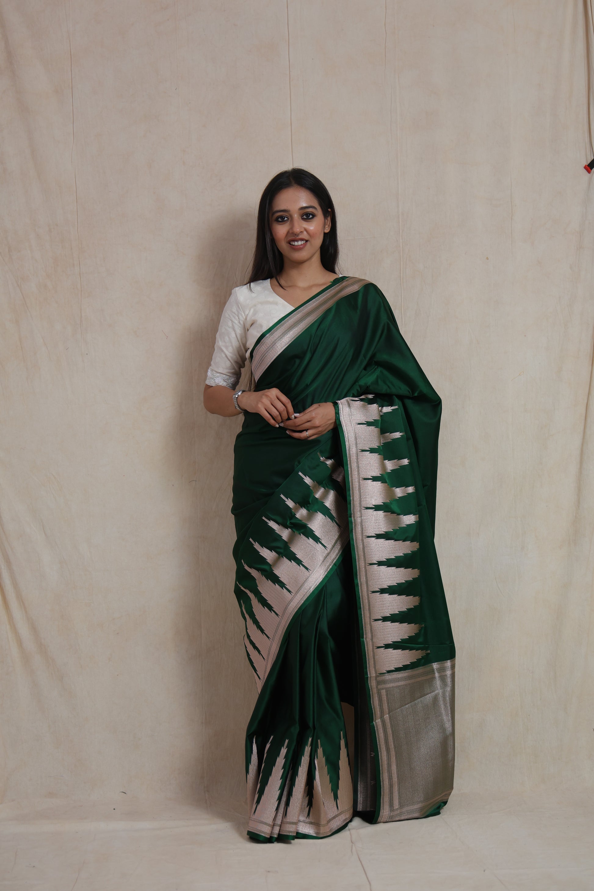Full-length view of emerald green Banarasi art silk saree with ornate silver border and pallu