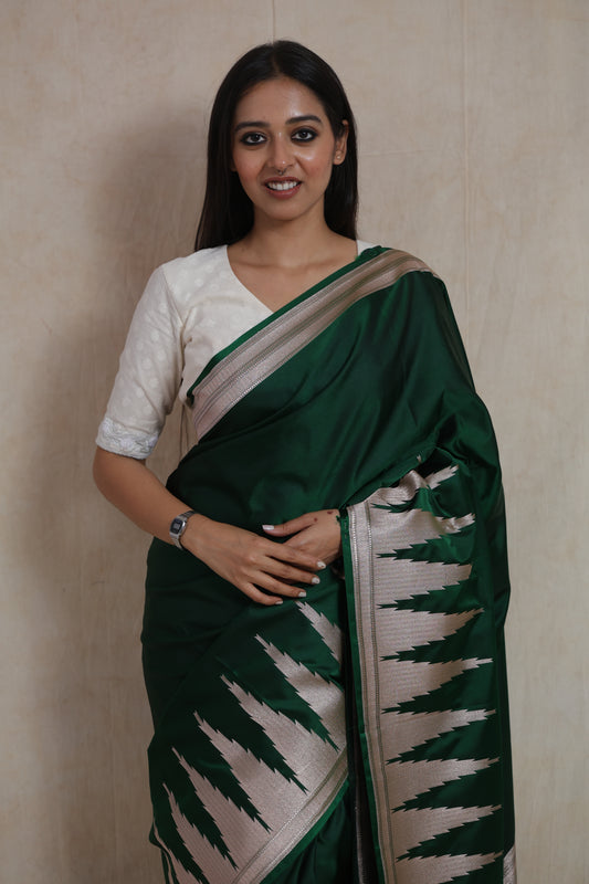 Portrait view of emerald green Banarasi art silk saree with elegant silver woven detailing