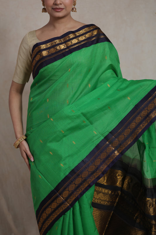 Close-up drape detail of emerald green Gadwal Sico saree with zari buttas
