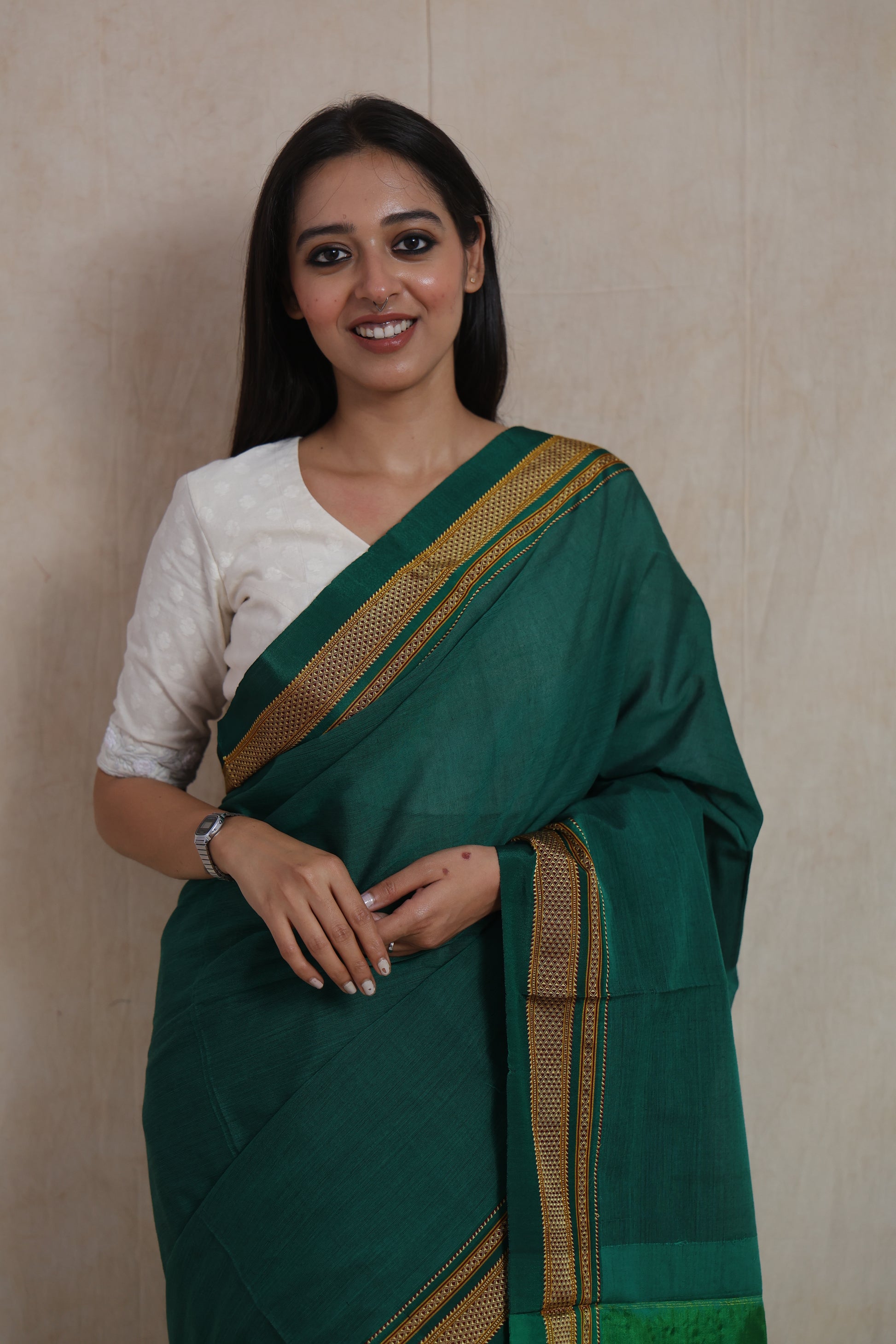 Close-up drape view of emerald green Ilkal cotton saree with traditional woven border