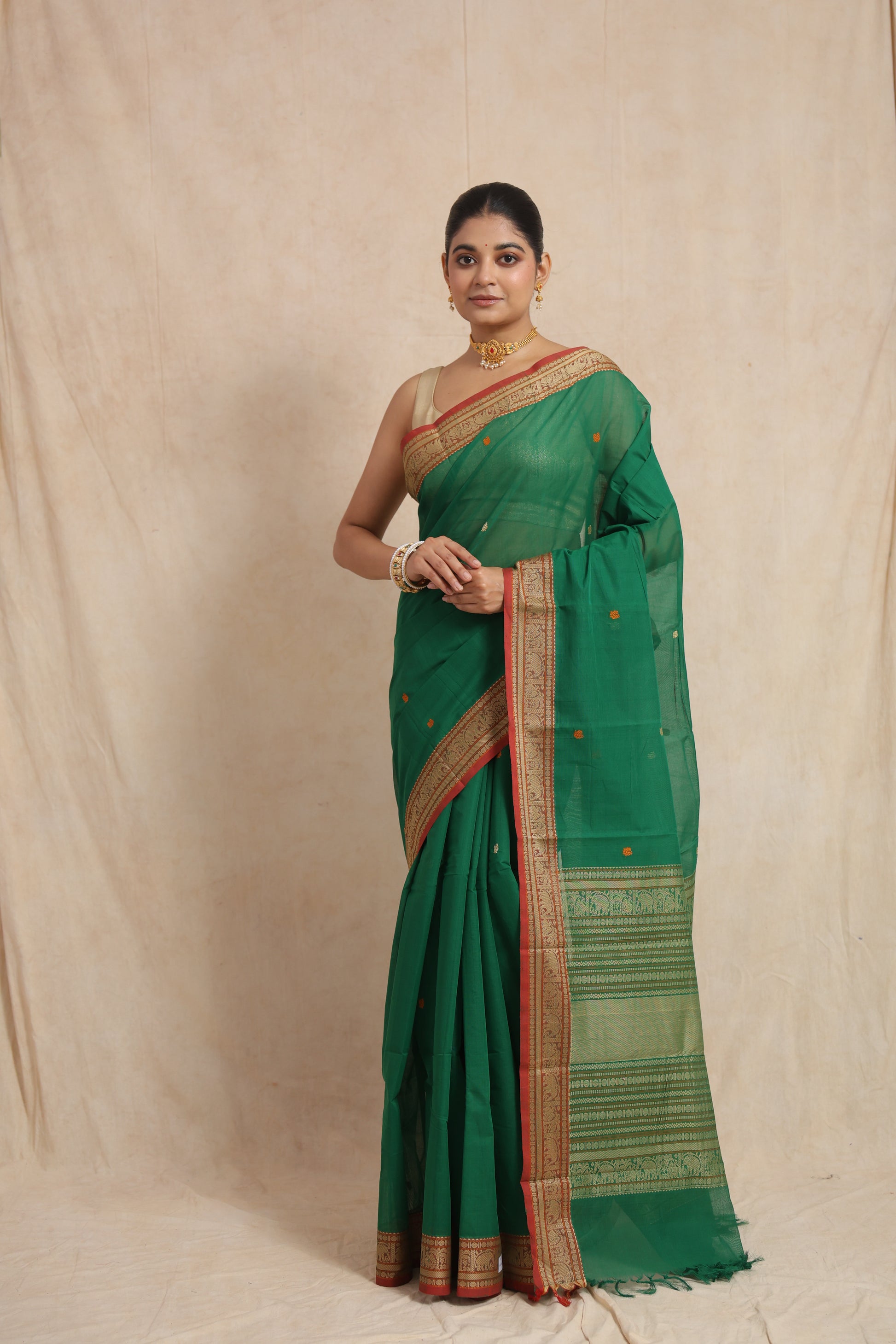 Classic pose in emerald green Kanchipuram cotton saree
