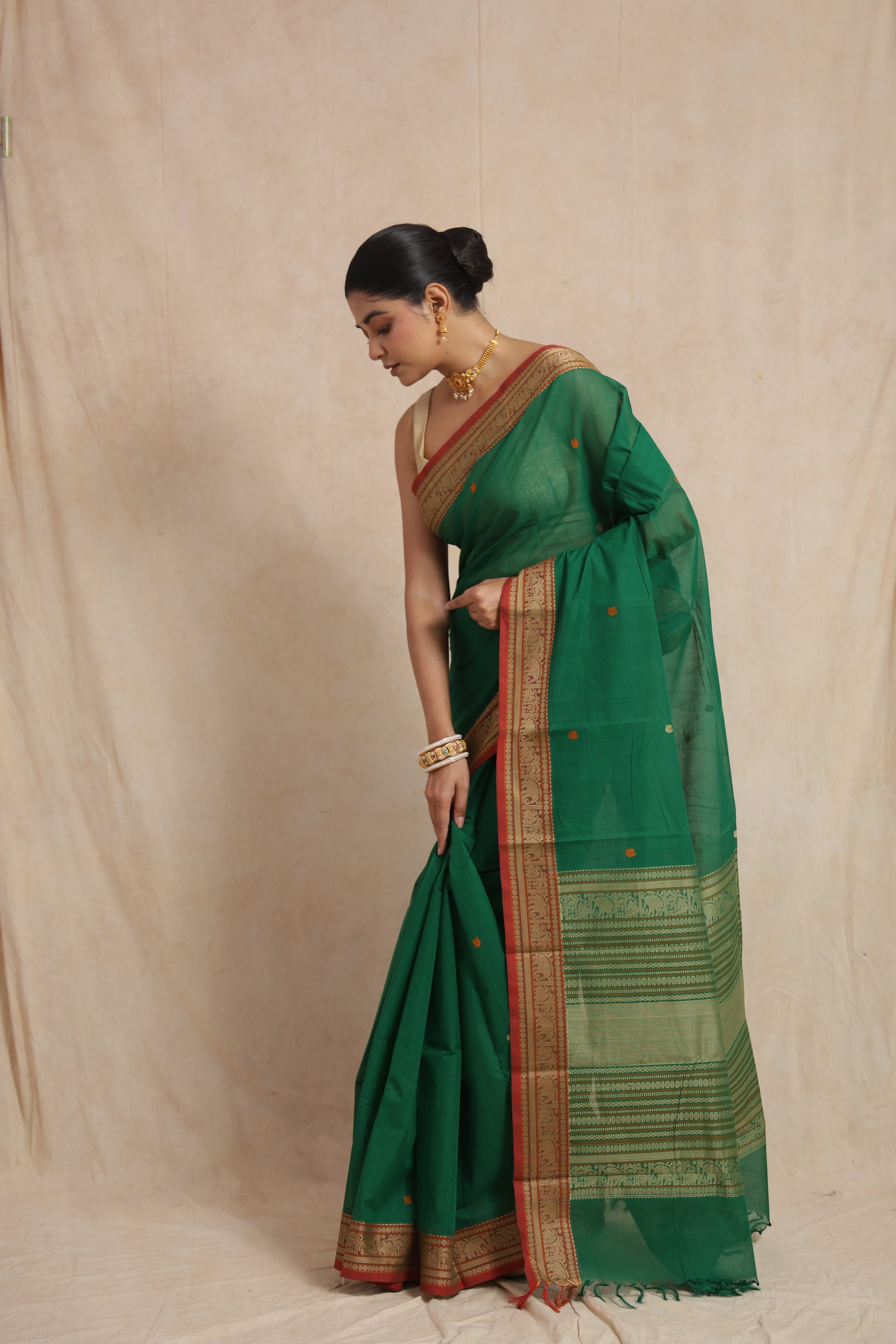 Side drape view of emerald green Kanchipuram cotton saree