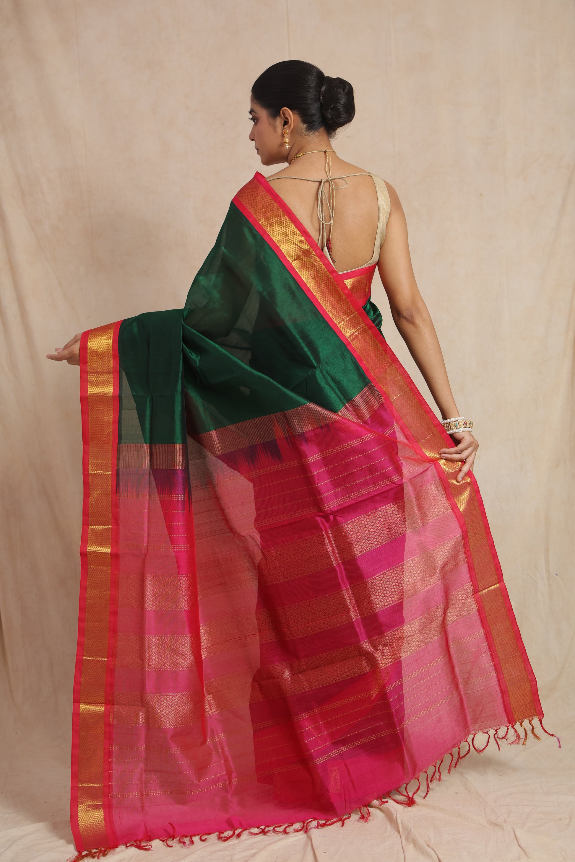 Back view of emerald green Kanchipuram Sico saree with rani pink woven pallu