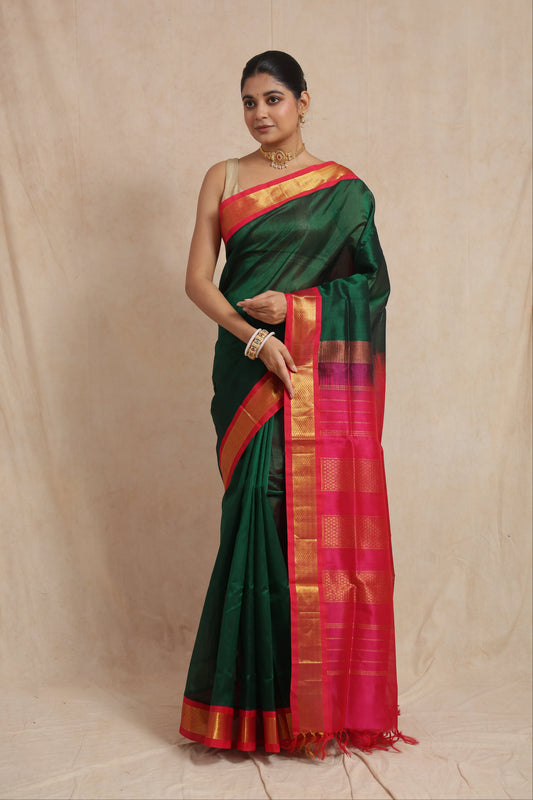 Full drape view of emerald green Kanchipuram Sico saree with rani pink zari border