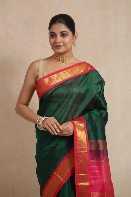 Portrait view of emerald green Kanchipuram Sico saree with golden zari woven border