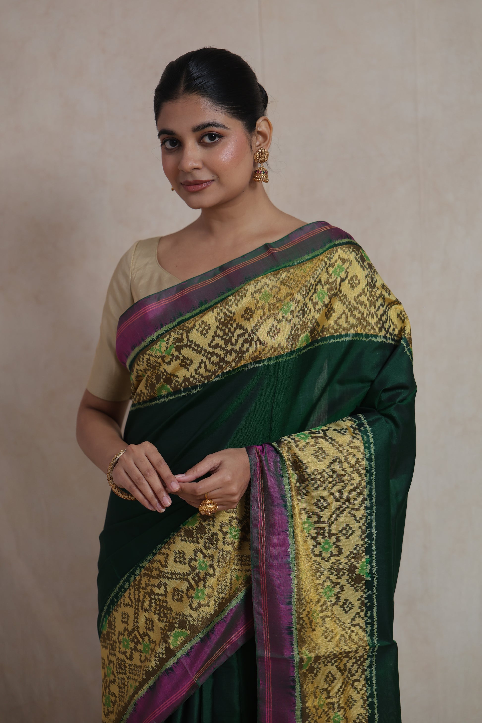Close-up of emerald green Patola silk saree with intricate traditional weaving