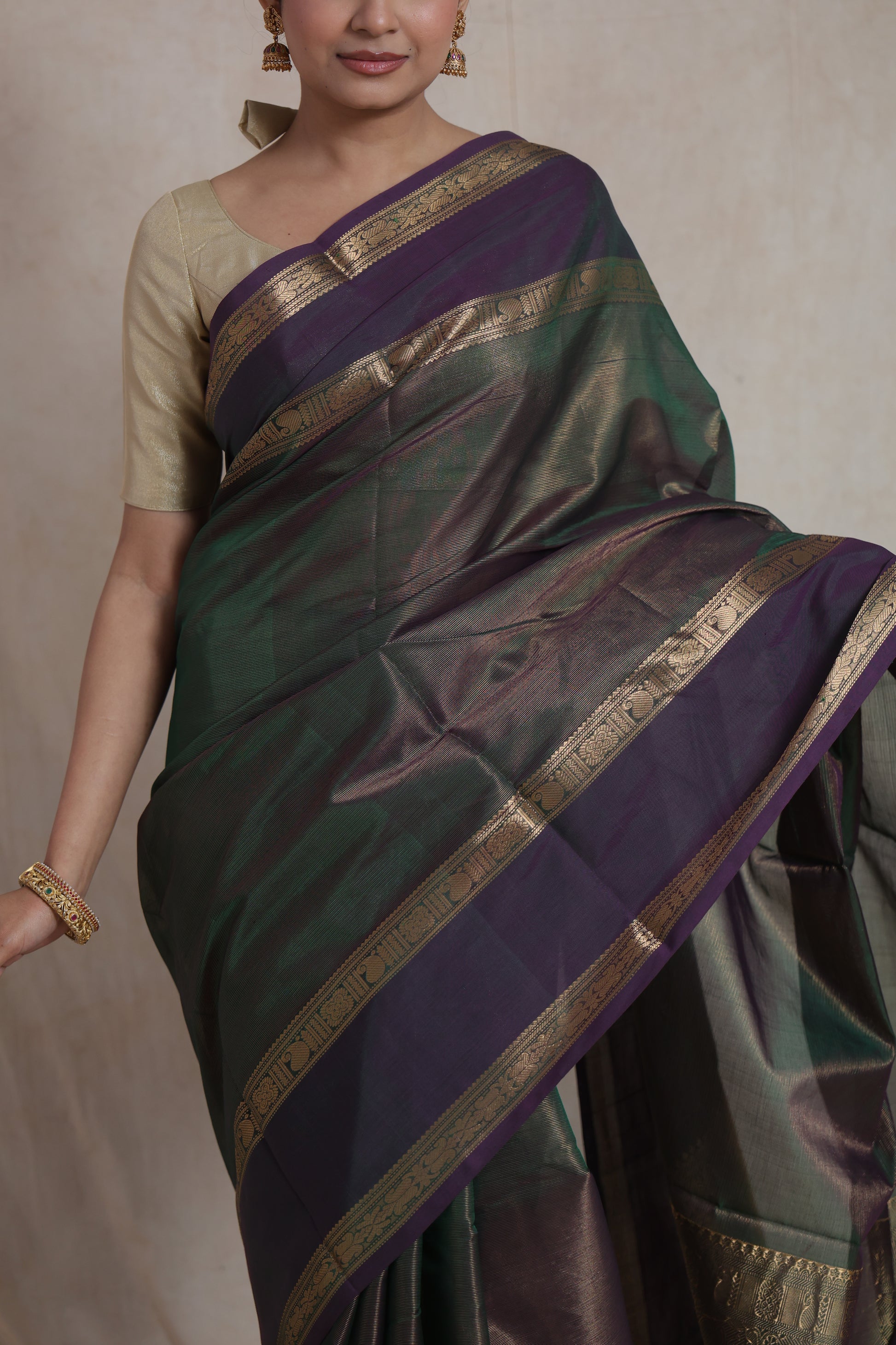 Close-up of dual-tone Kanchipuram silk saree with traditional gold woven border