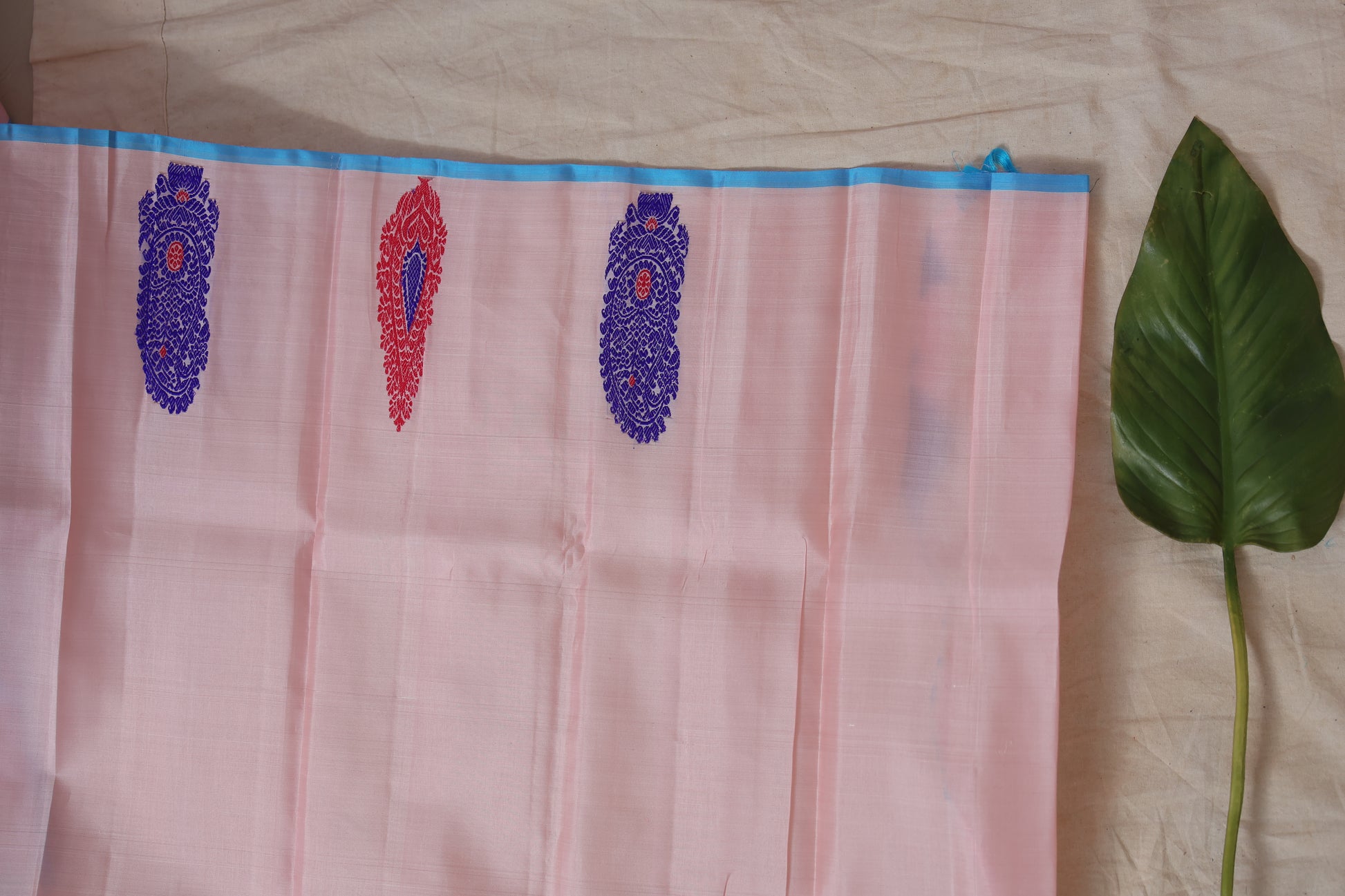 Festive pastel pink Gadwal silk saree with vibrant woven motifs