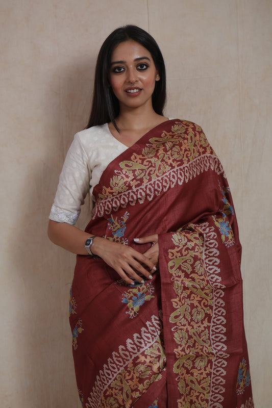 Close-up of rust brown Batik silk saree with handcrafted floral and paisley border
