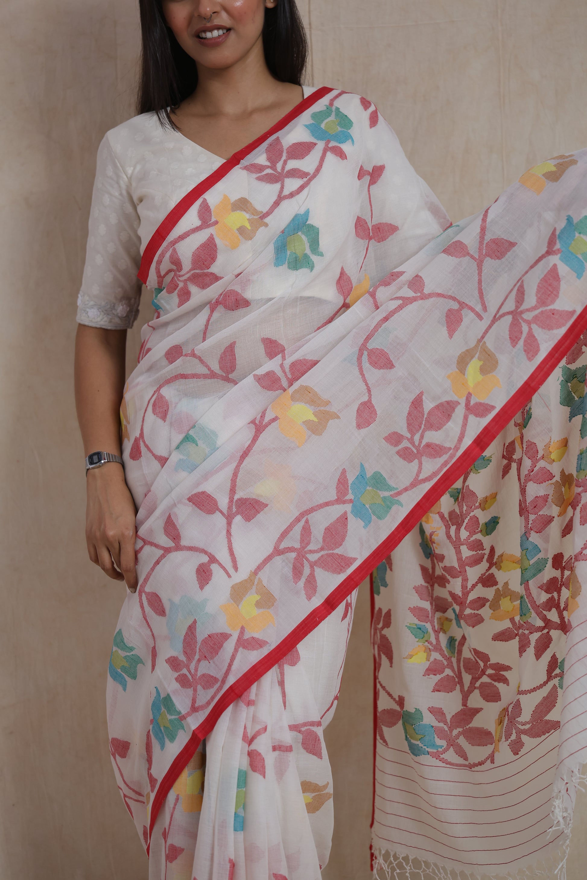 Close-up of multicolor floral motifs woven on ivory white Bengal Cotton Fulia saree