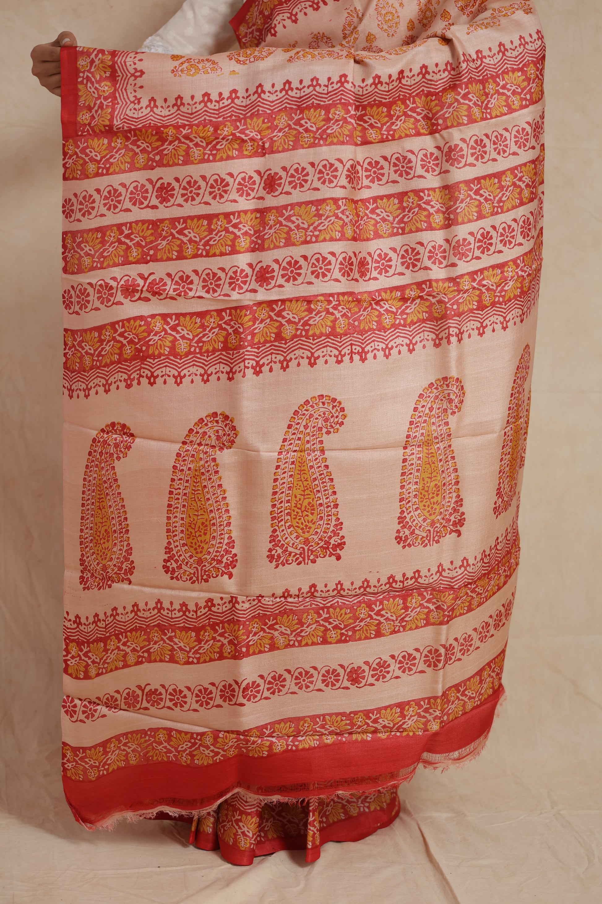 Detailed pallu of blush pink Batik silk saree featuring floral and paisley patterns