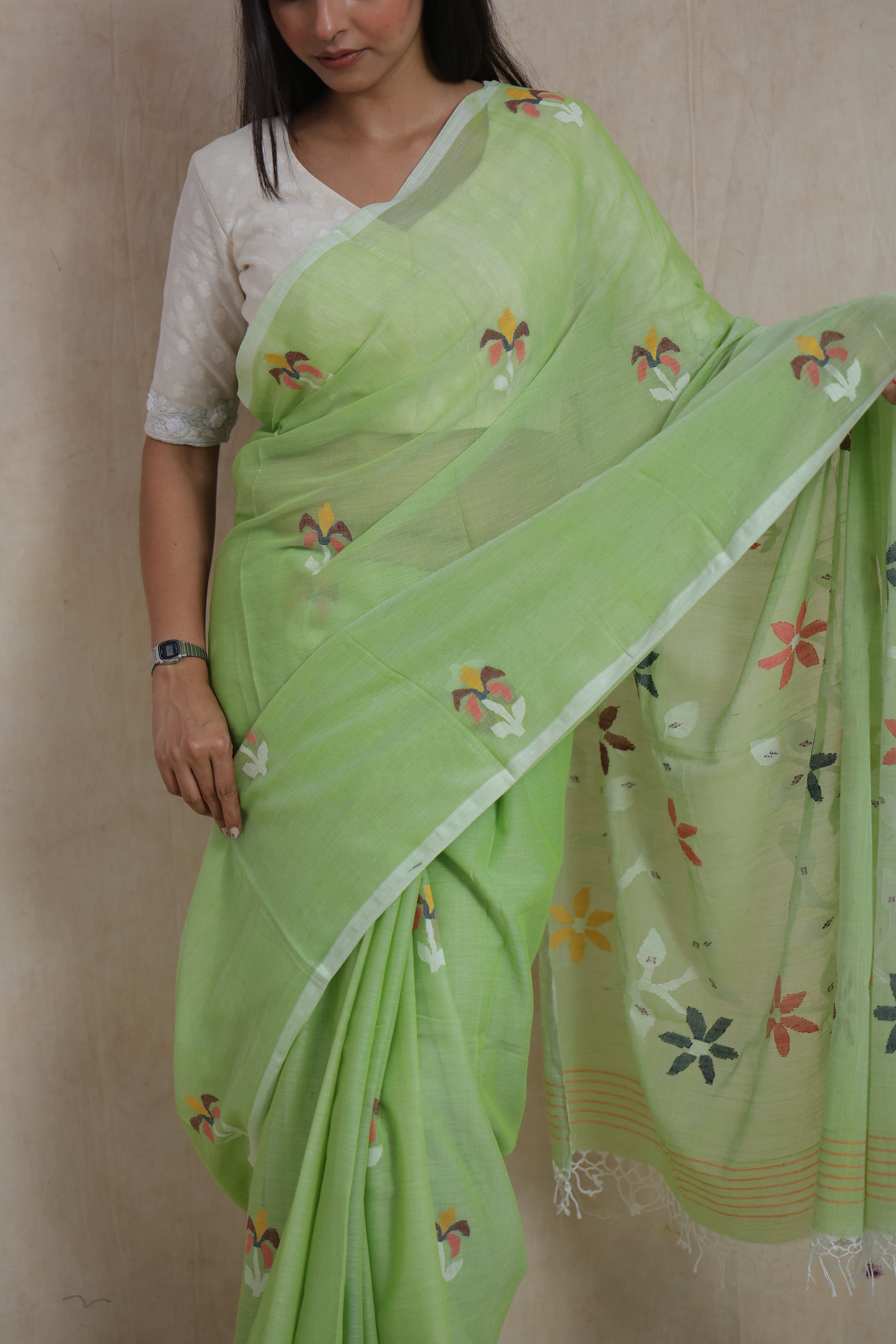 Elegant pistachio green Bengal Cotton Fulia saree with handcrafted floral motifs and soft cotton texture