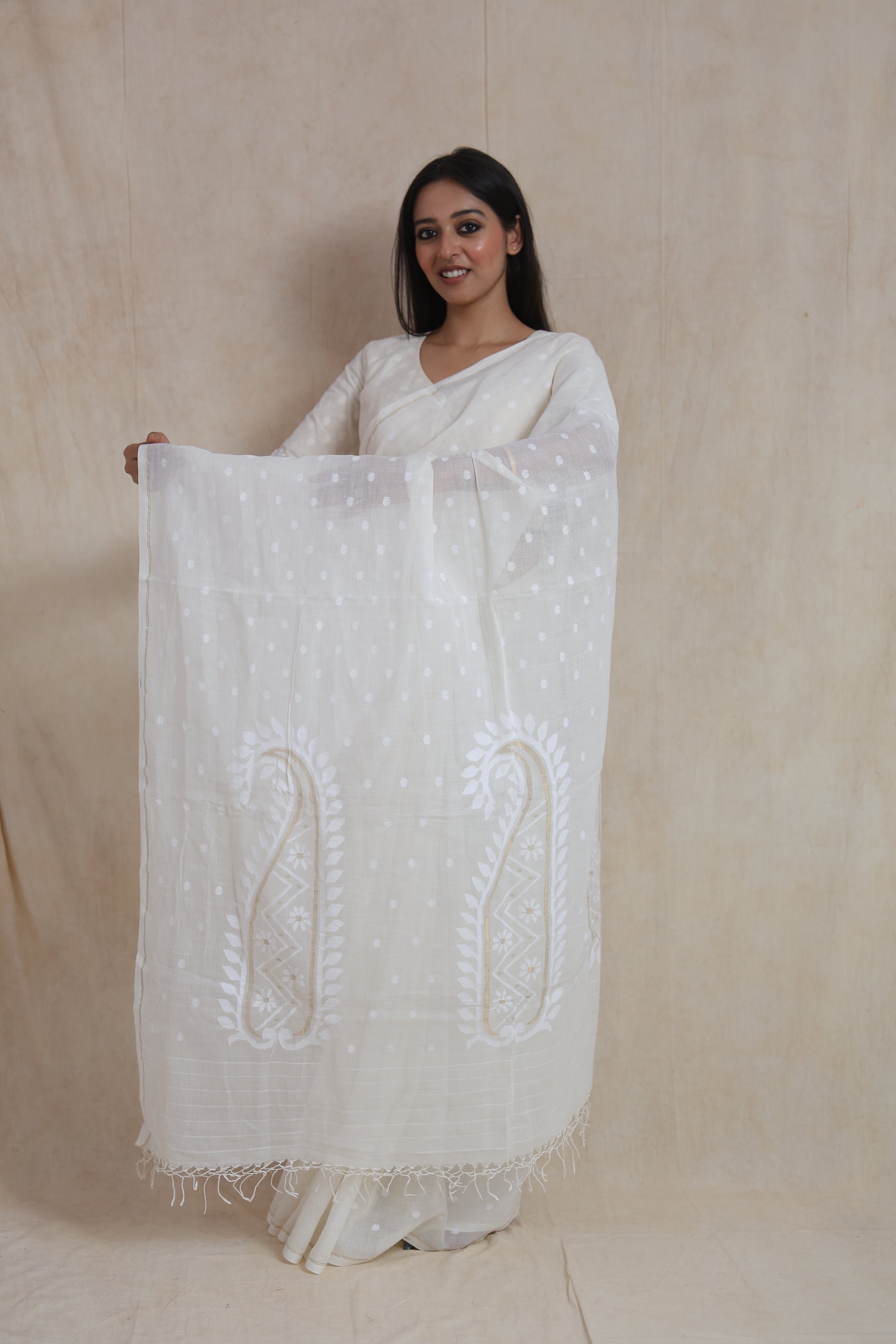 Fabric detail of off-white Bengal Fulia cotton saree featuring subtle woven butti patterns and fine texture