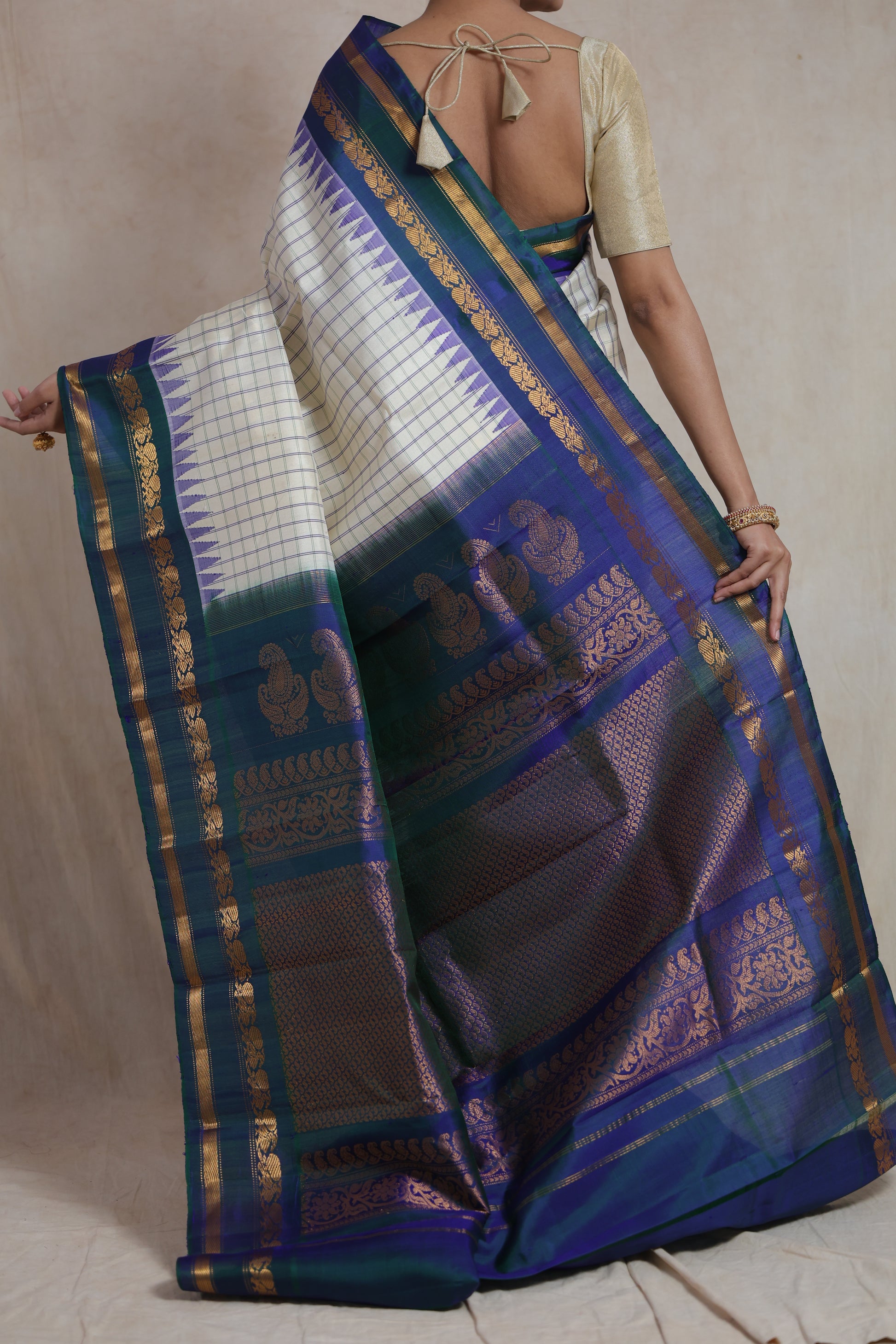 Back drape view of ivory Gadwal silk saree with intricate zari pallu