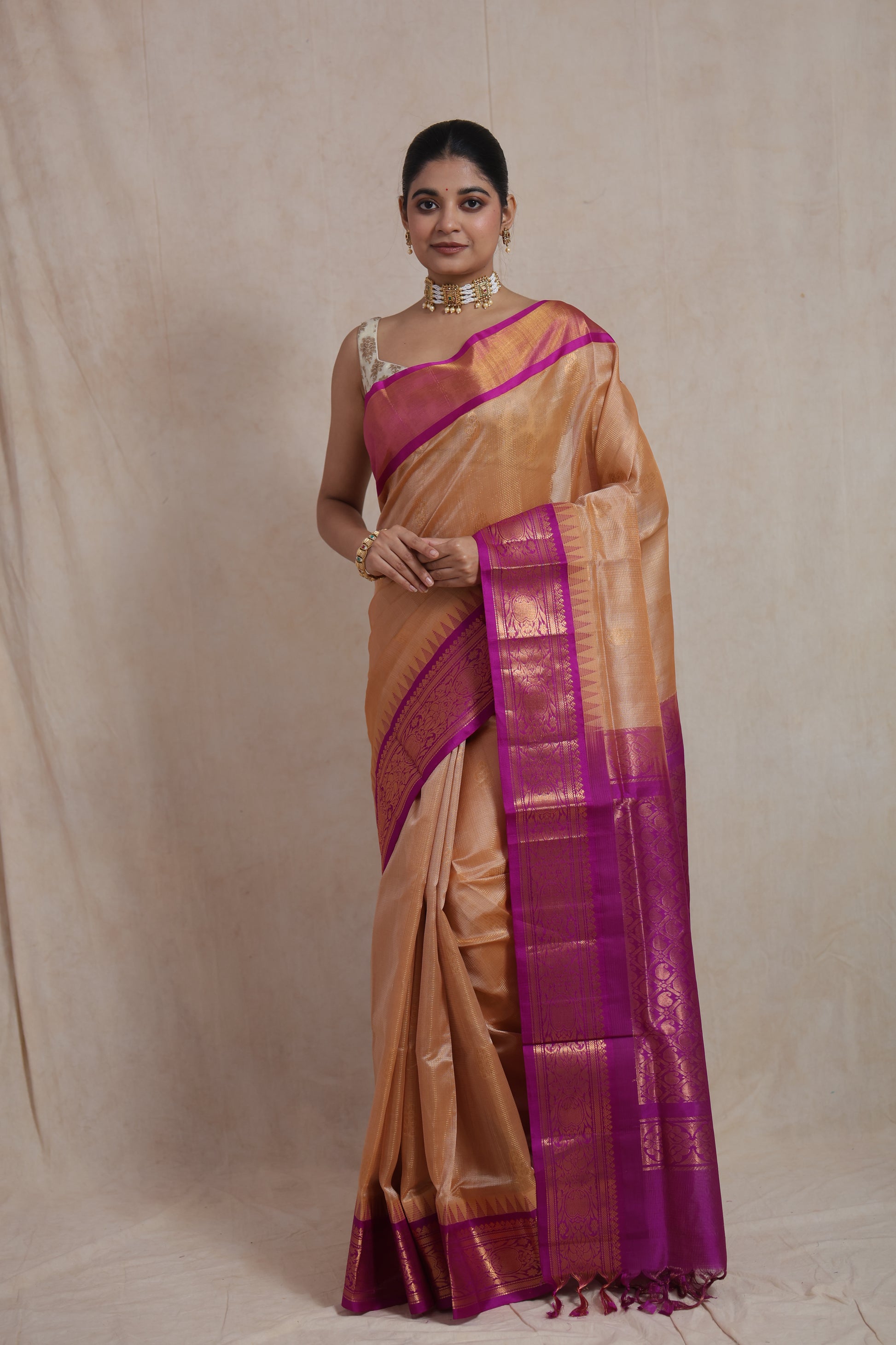 Full view of golden beige Kanchipuram Sico saree with magenta zari woven border