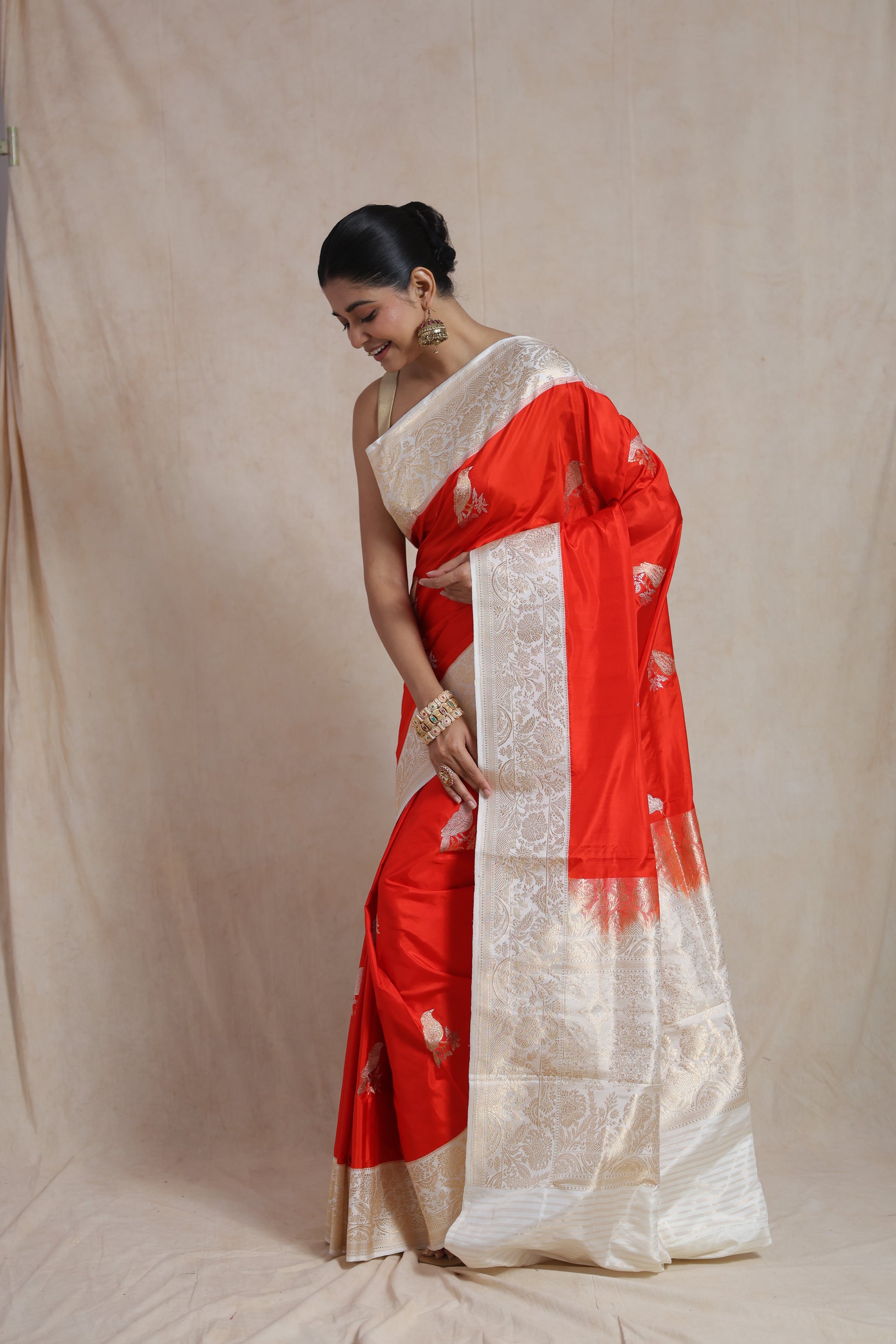 Rich woven pallu of vermilion Banarsee silk saree with floral zari artistry