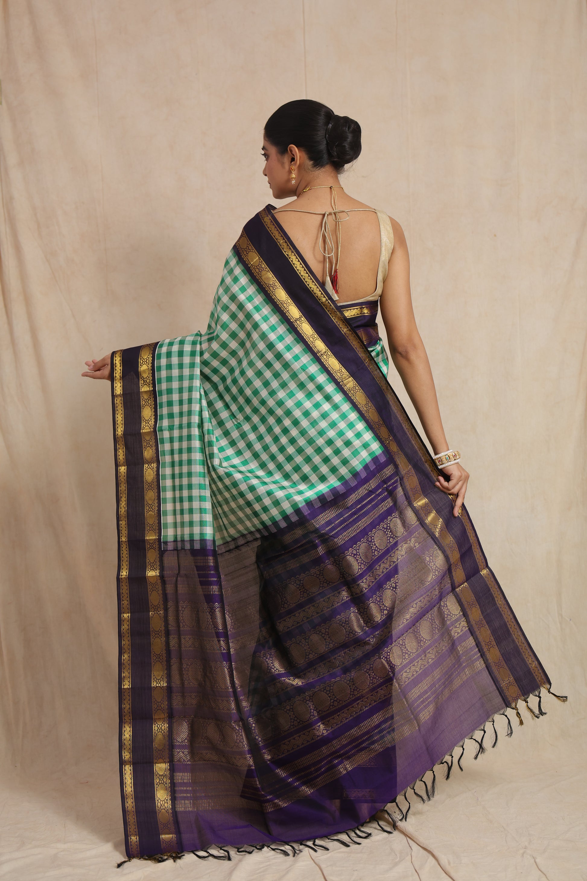 Back view of green checked Kanchipuram Sico saree with royal purple zari woven pallu