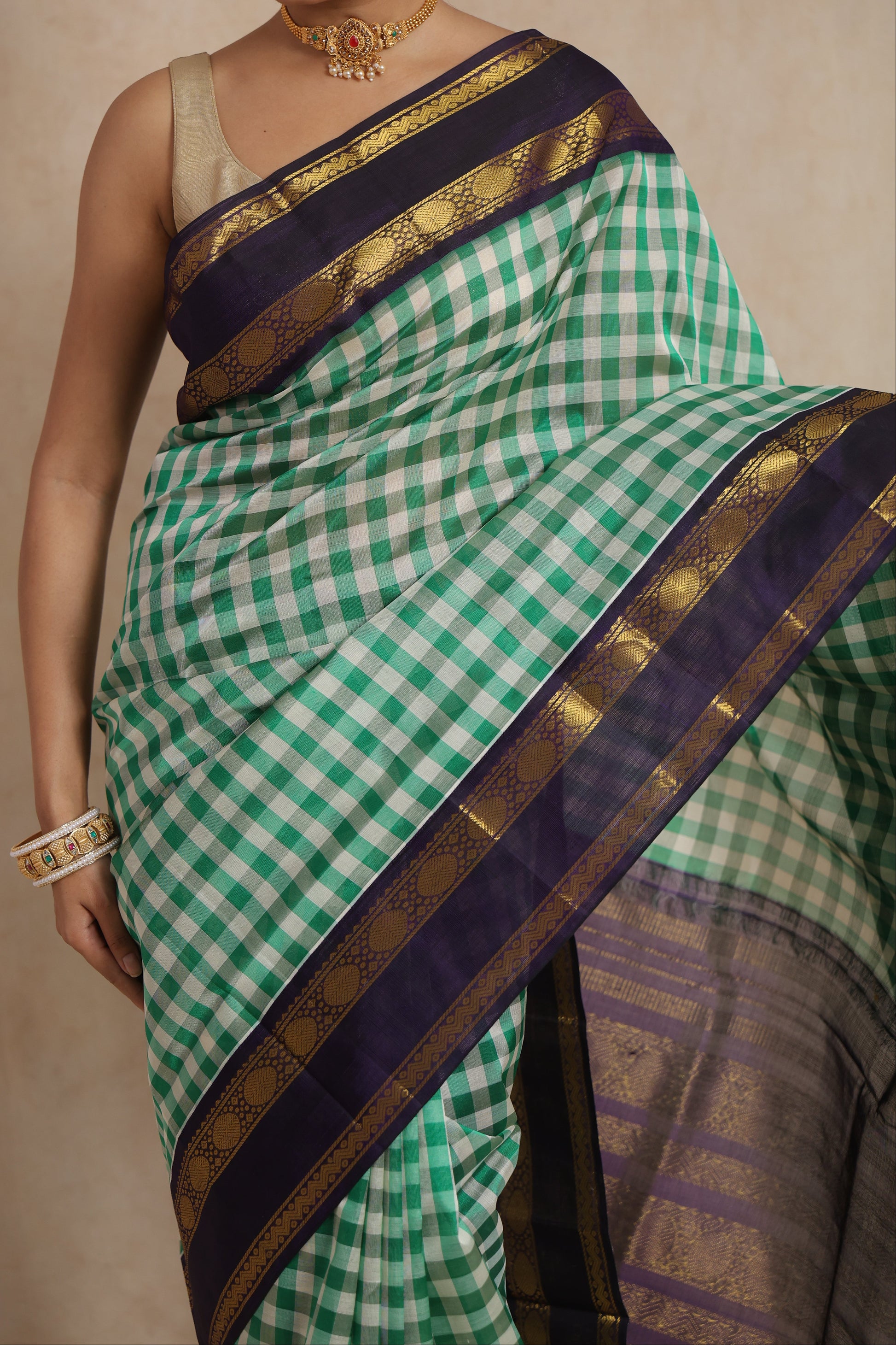 Close-up of green checked Kanchipuram Sico saree with purple zari woven border