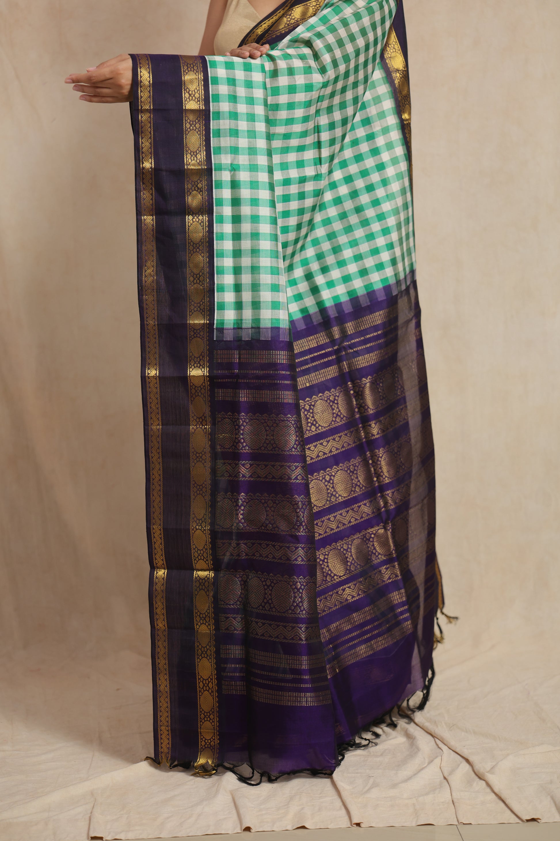 Detailed pallu view of green checked Kanchipuram Sico saree with intricate zari motifs