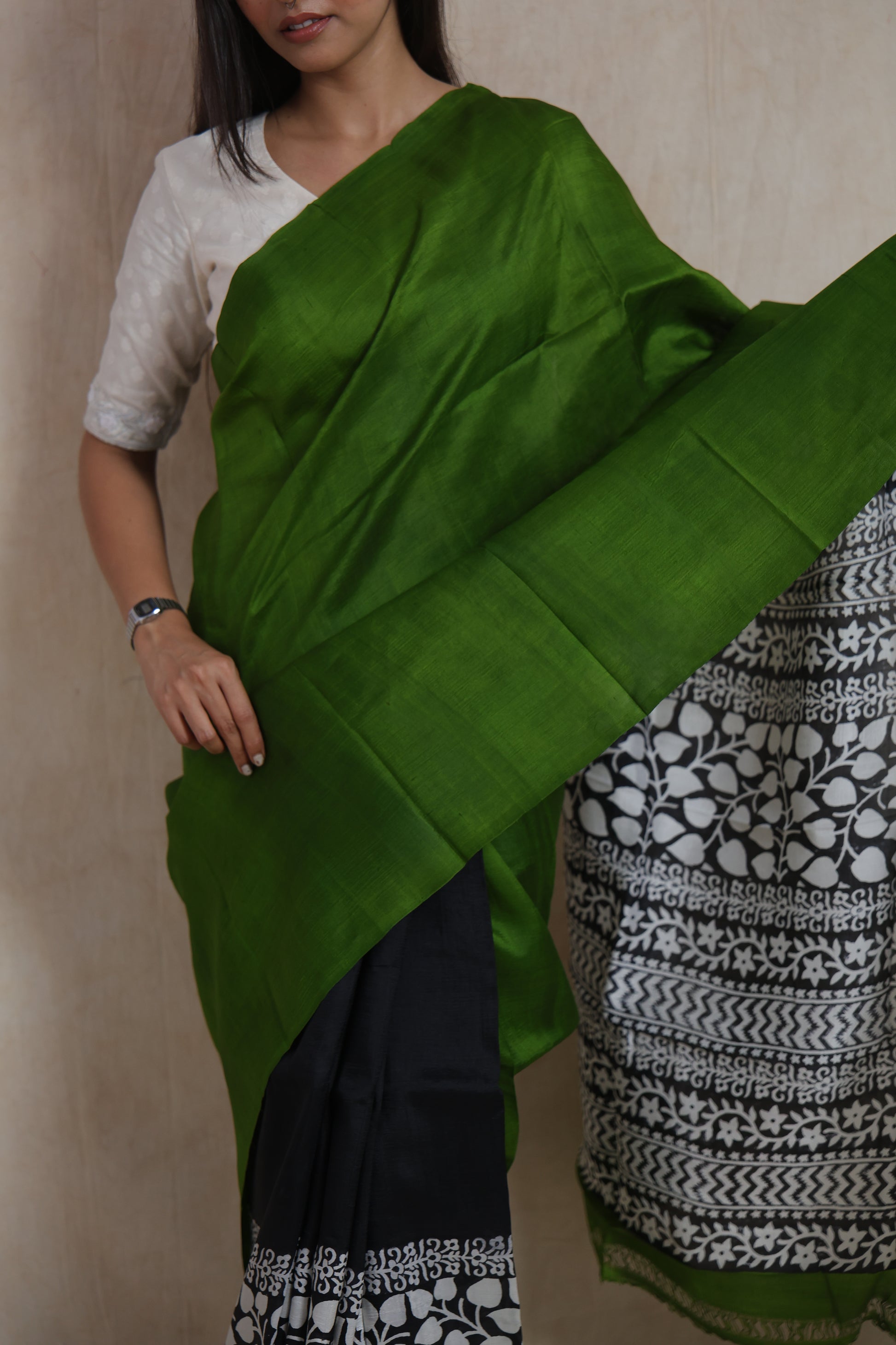 Close-up of emerald green Garad silk saree showcasing smooth silk texture and contrast pallu
