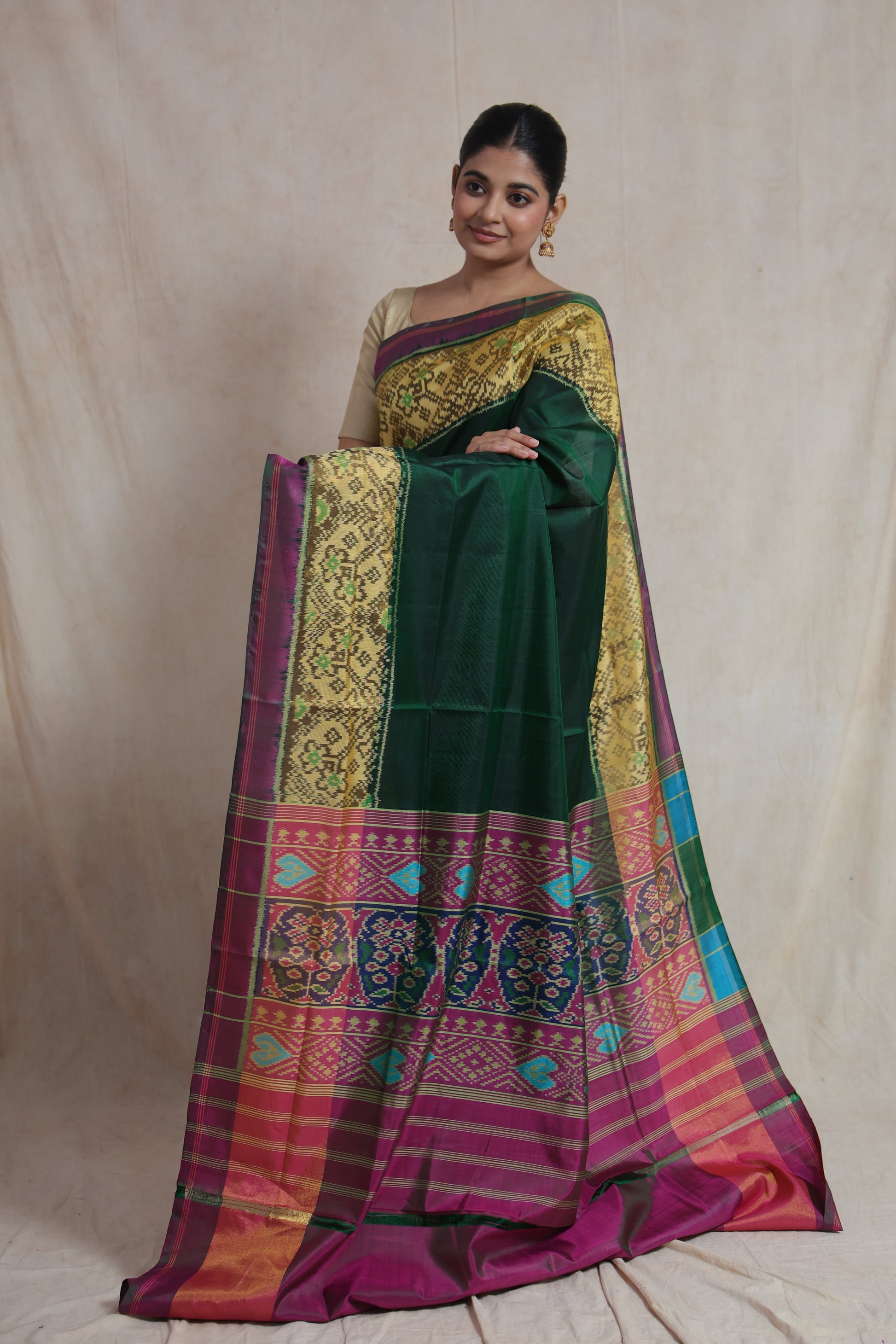 Full view of elegant green Patola silk saree with traditional woven border