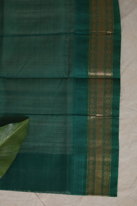Closeup of emerald green zari border on Kanchipuram silk cotton saree