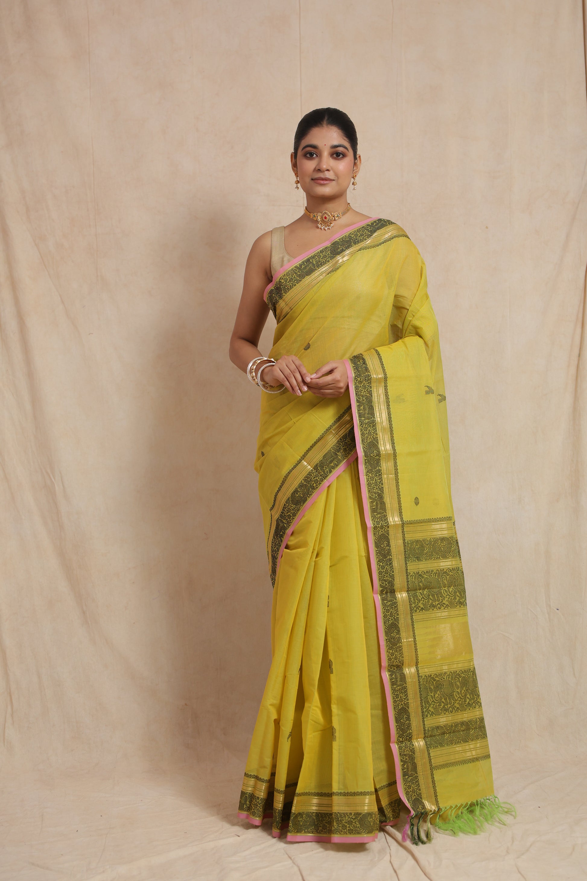 Detailed border design of greenish yellow Kanchipuram cotton saree