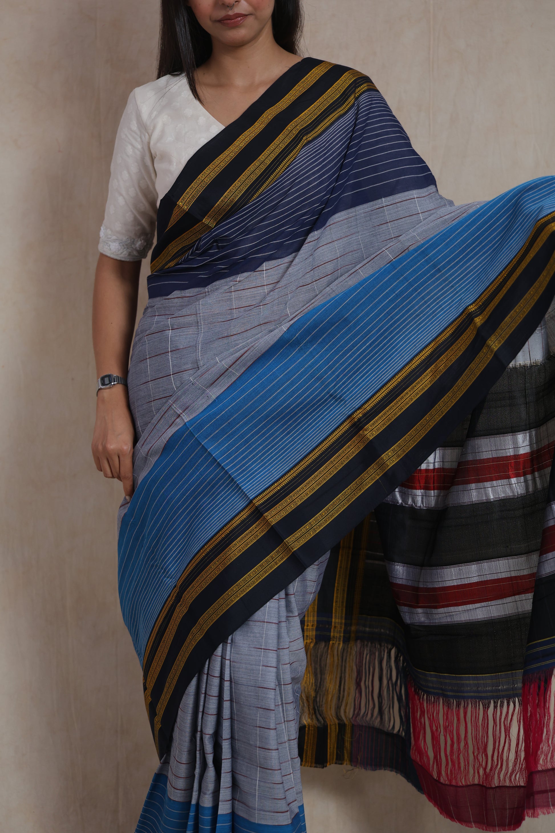 Close-up of grey and blue Ilkal handloom cotton saree with striped weave and contrast border