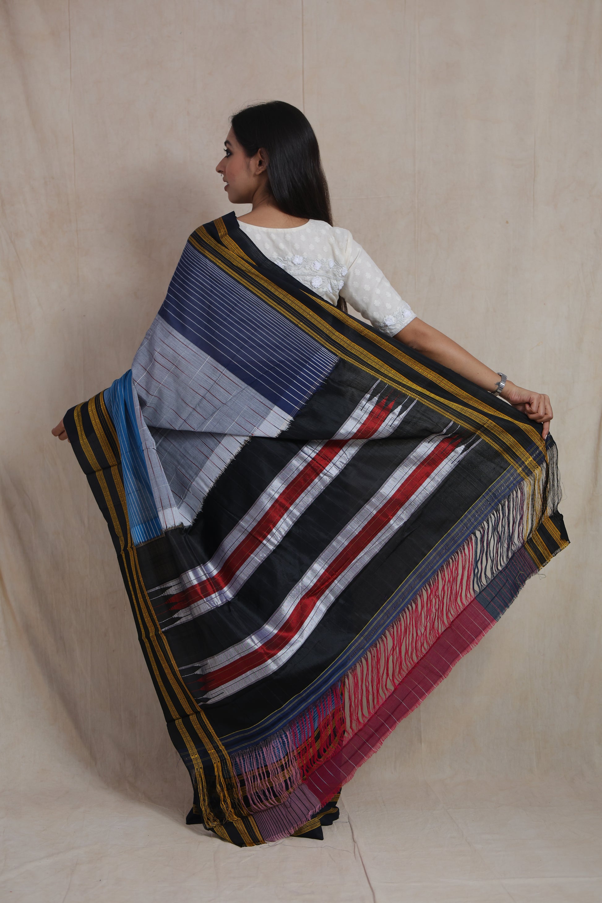 Back view of grey and indigo Ilkal handloom cotton saree featuring traditional Tope Teni pallu